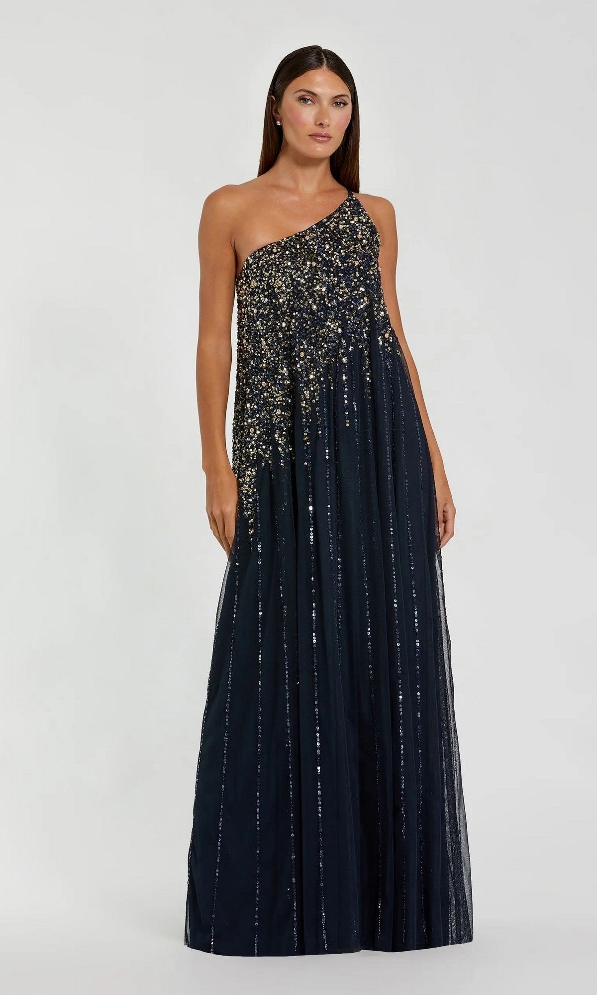 A woman wears the Mac Duggal 9224—an elegant one-shoulder long formal dress in black, featuring silver sequin embellishments and vertical stripes—perfect for evening or formal events.