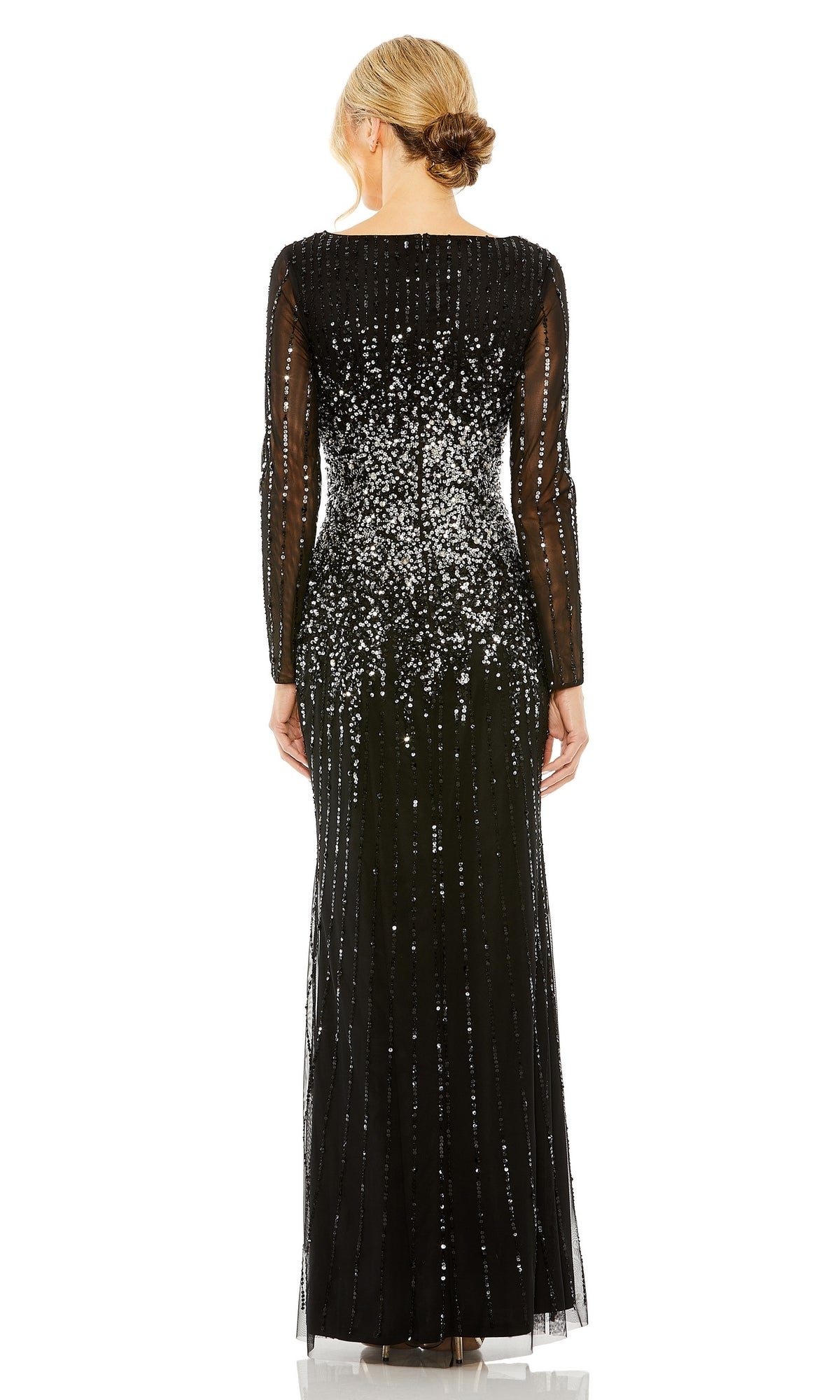 A woman with her hair in a low bun stands with her back to the camera, wearing the Mac Duggal 9226 Long Sleeve Sequin Formal Gown—floor-length, black, and adorned with silver sequins.