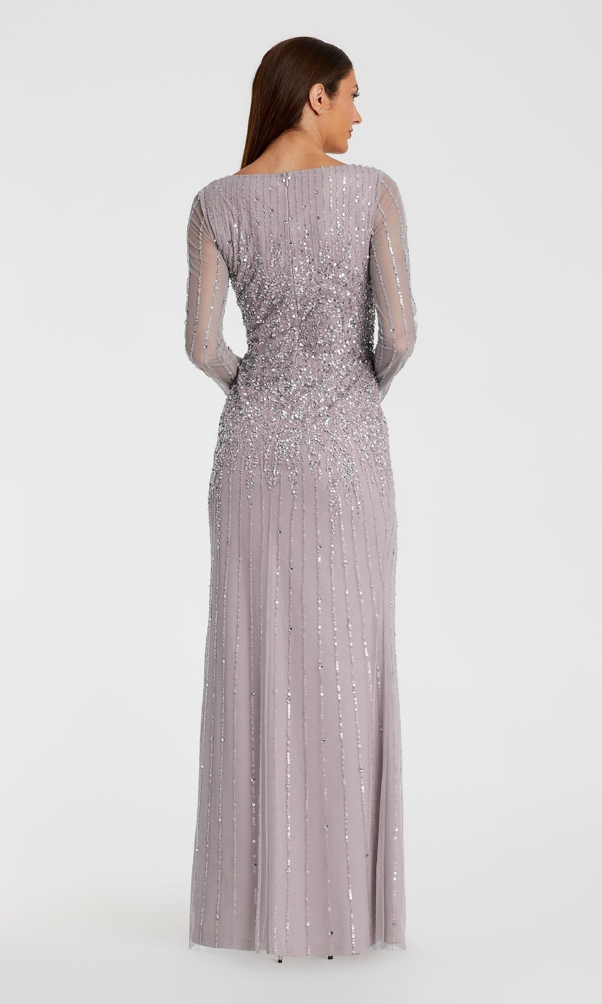 A woman faces away, modeling the Mac Duggal 9226 Long Sleeve Sequin Formal Gown—a floor-length, light purple evening dress with bead embellishments—against a plain white background.
