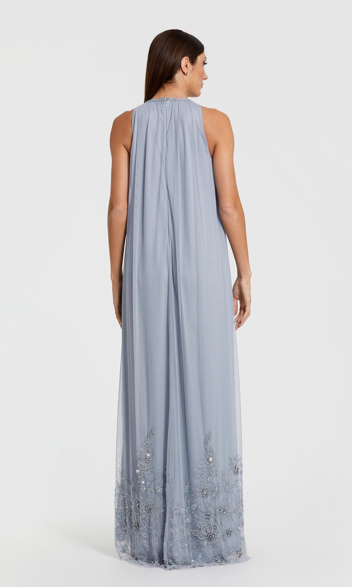 Woman shown from the back in a sleeveless, floor-length nude gold trapeze formal gown, reminiscent of Mac Duggal 9232, against a plain background.