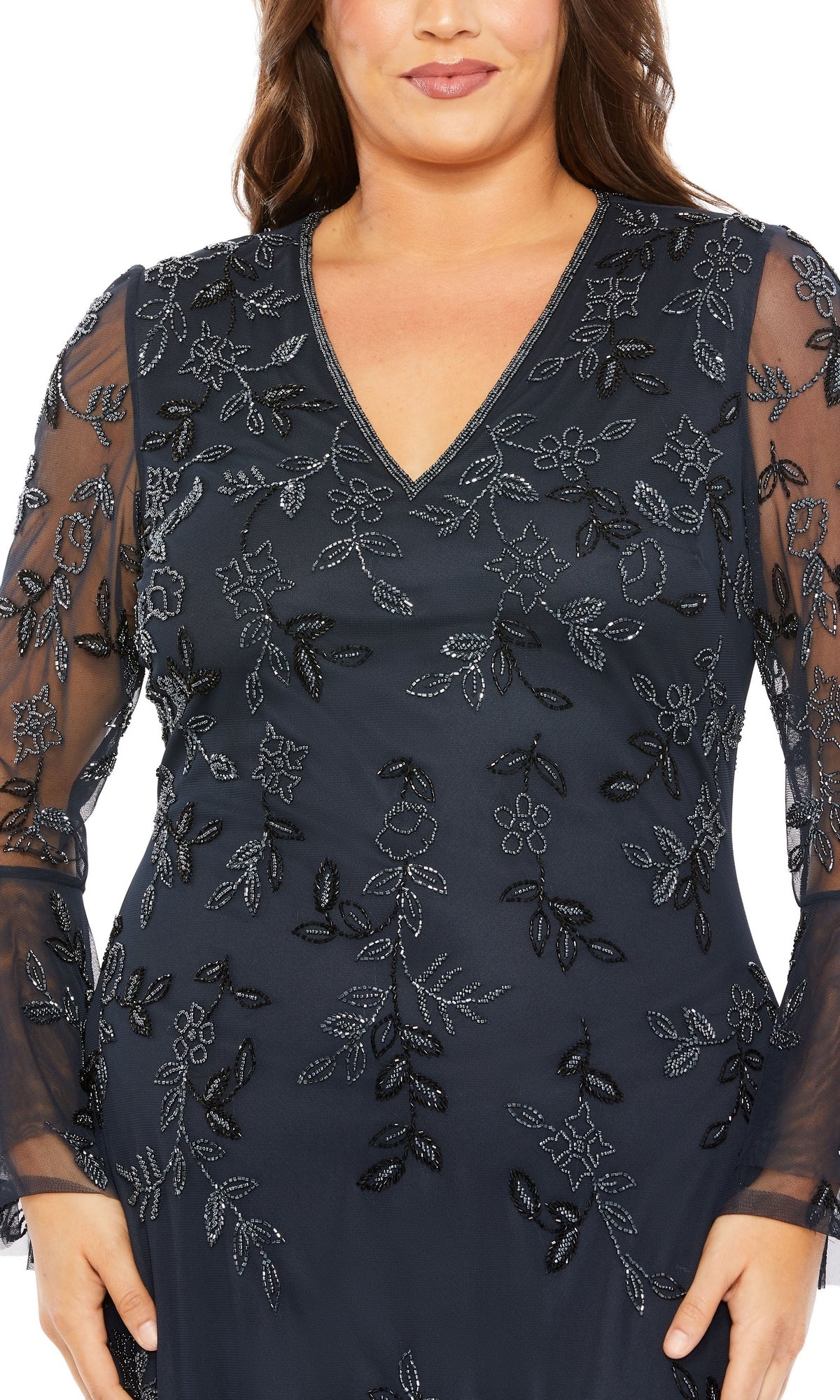 A woman wearing the Long Plus-Size Formal Dress 9239 by Mac Duggal in midnight blue, featuring sheer long sleeves and intricate floral embroidery on the bodice and sleeves.