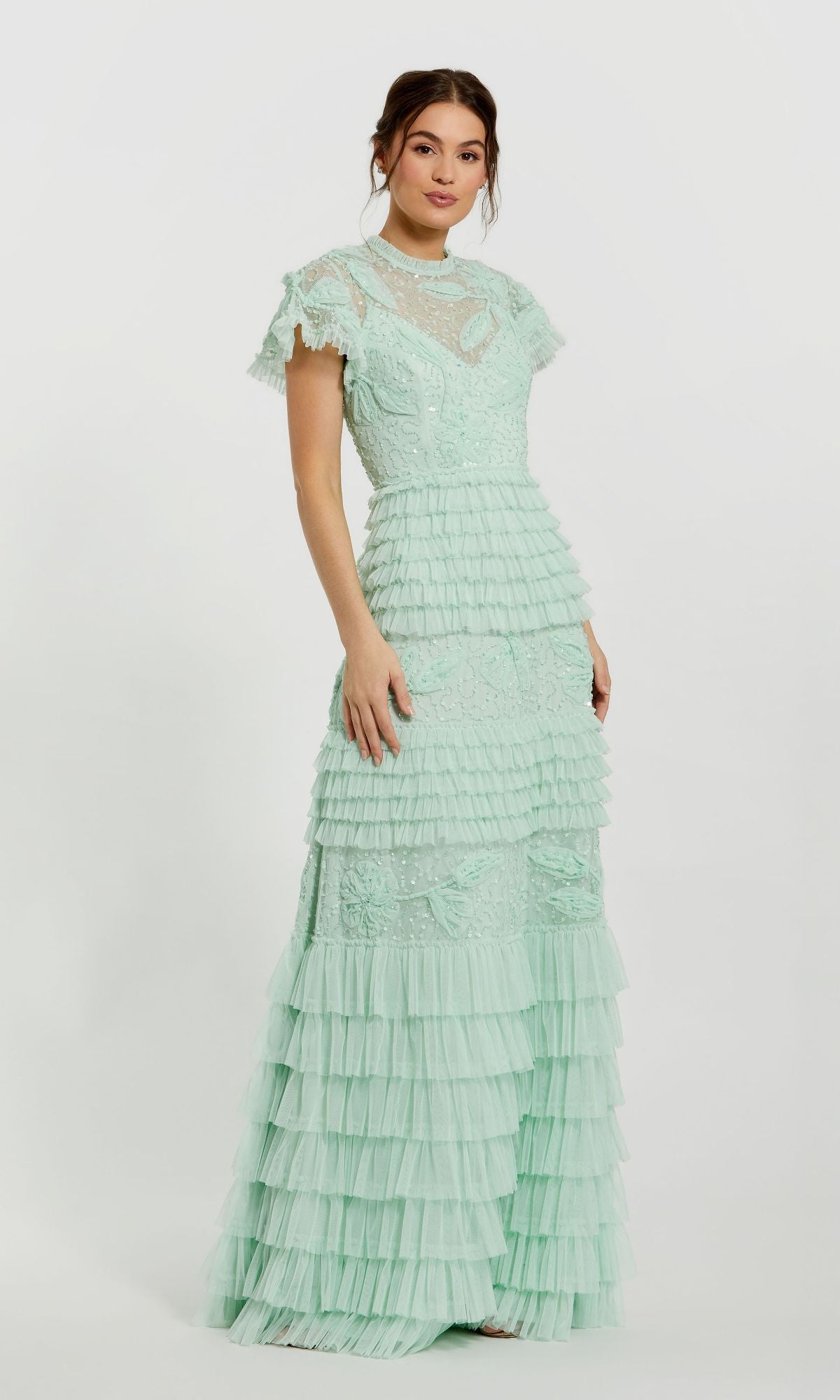 A woman models the Mac Duggal 9278 long sage green formal dress, featuring lace details and ruffled tiers, standing against a plain white background.