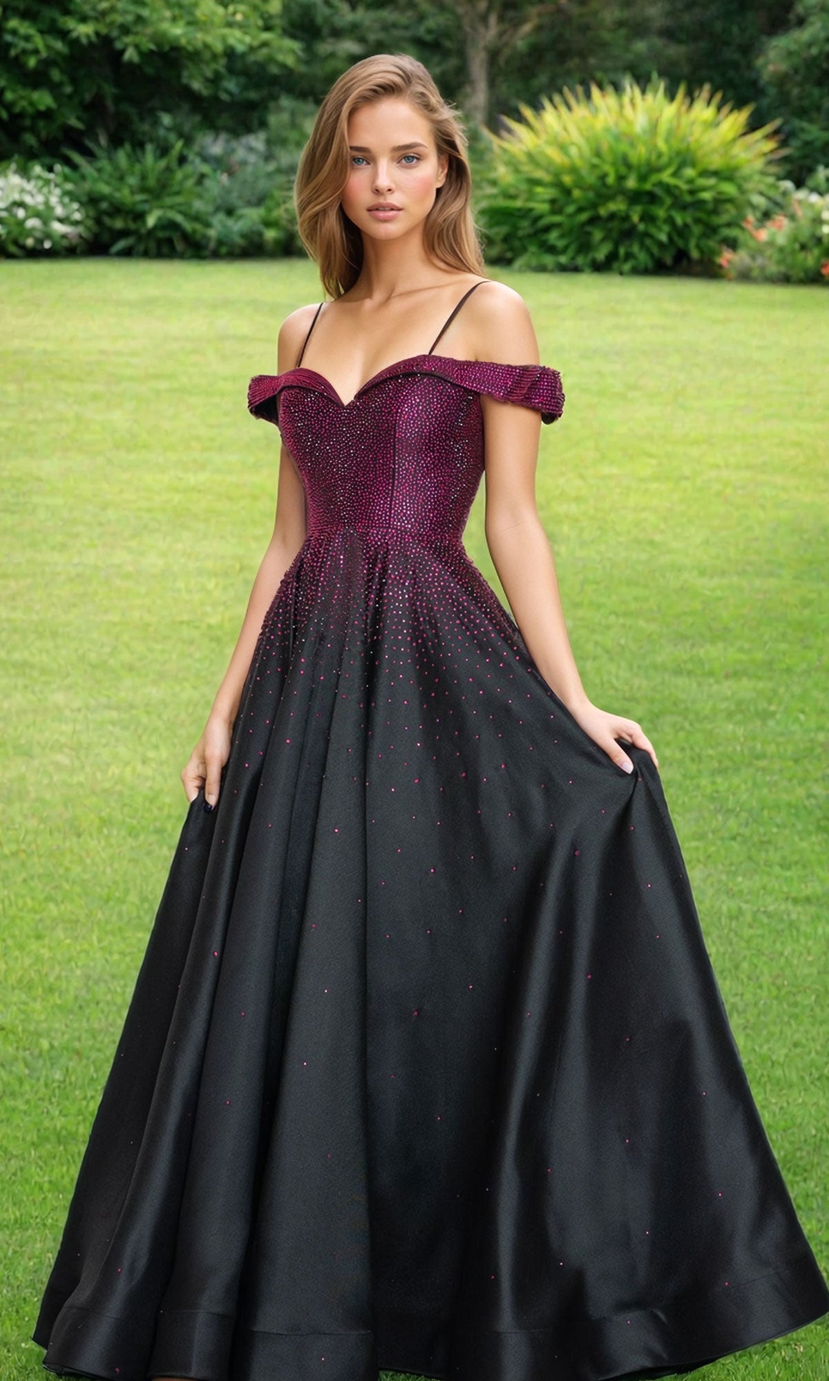 A woman stands on grass wearing the Cold-Shoulder Beaded Long Prom Ball Gown 9278 in black/hot pink. The beaded bodice and cold-shoulder style add elegance, with shrubs and greenery creating a lush backdrop.