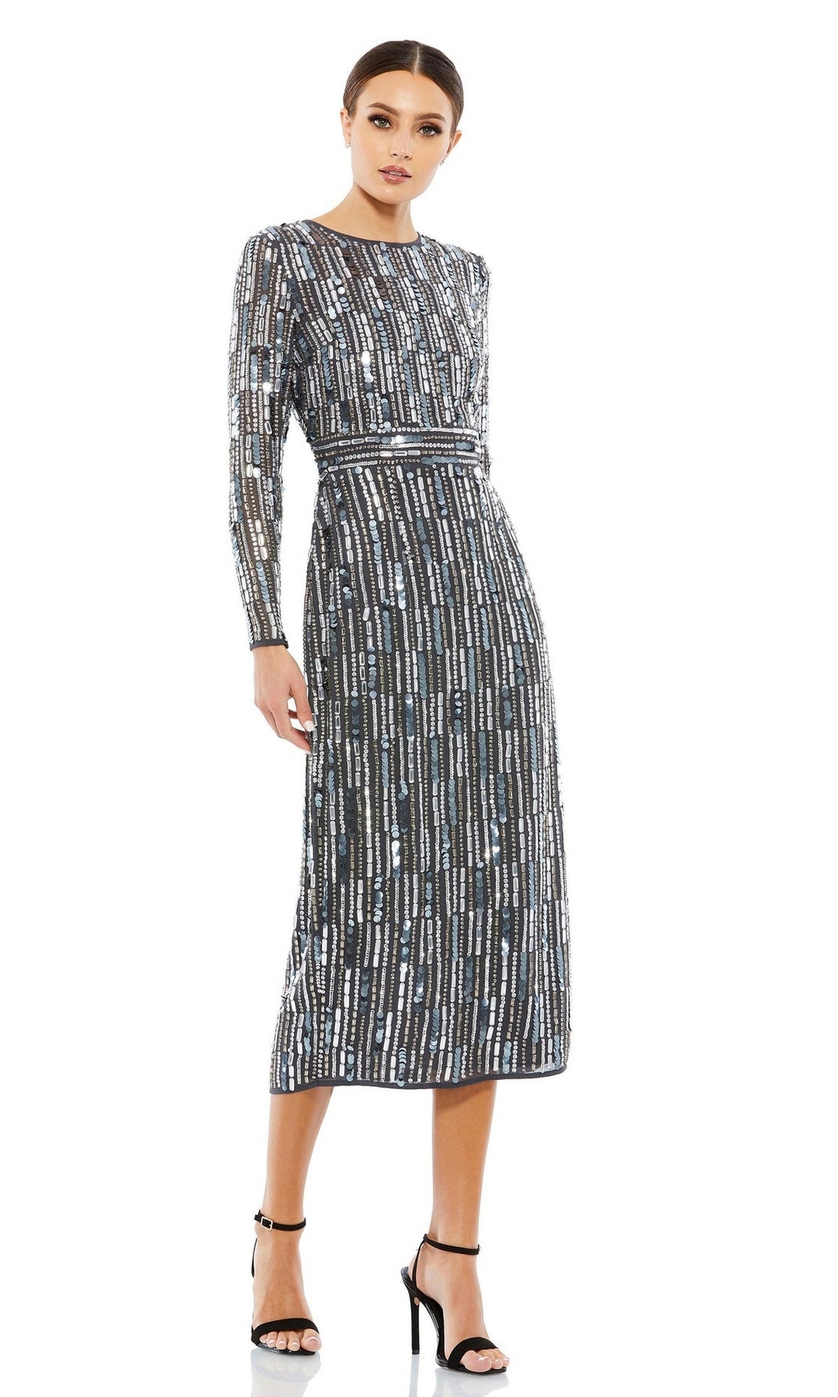 Woman modeling the Mac Duggal Beaded Striped Wedding-Guest Dress 93590A in charcoal silver, featuring a fitted waist and beaded stripe pattern. She pairs it with black high-heeled sandals, making an elegant wedding guest look.