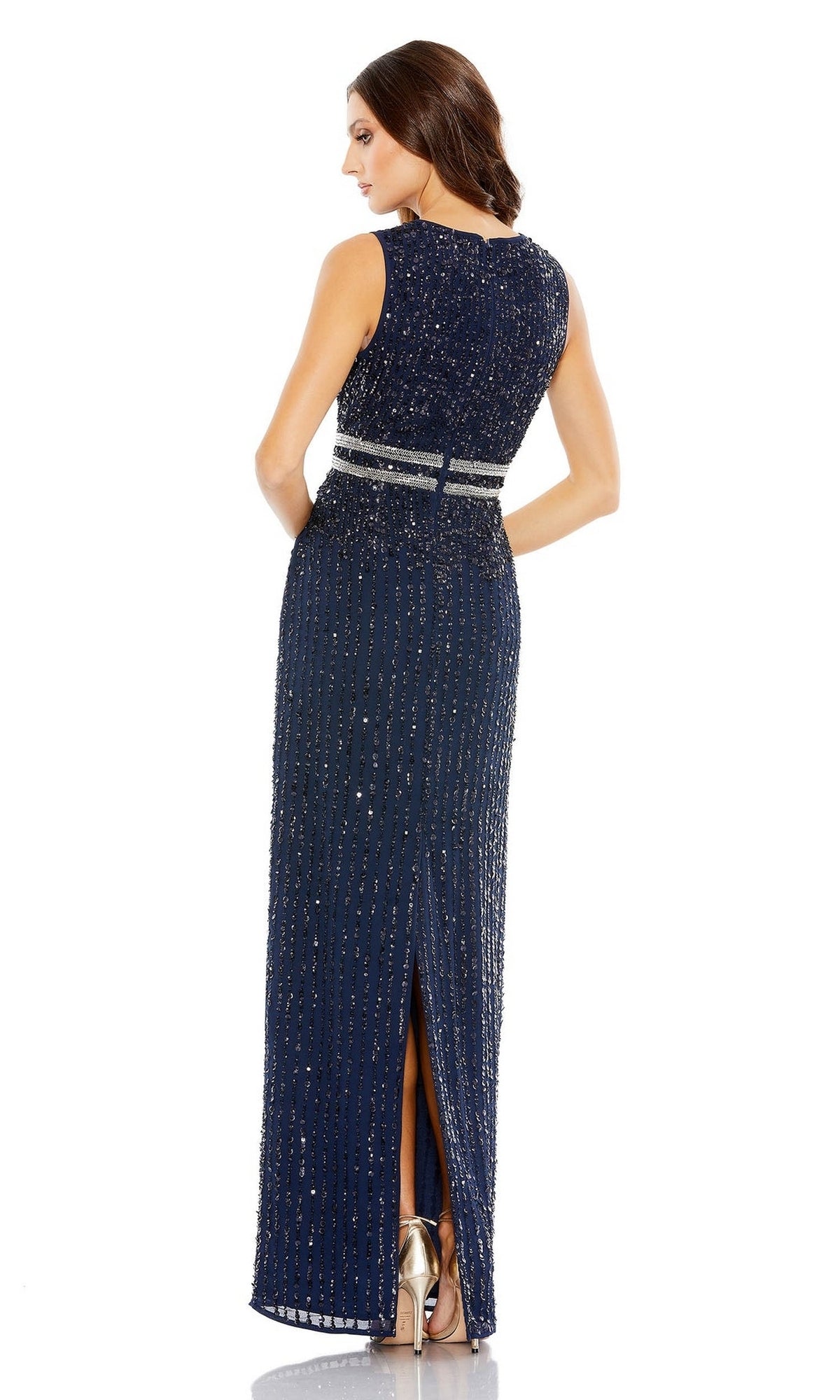 Woman wearing the Sleeveless Sequin Formal Dress: Mac Duggal 93603—navy blue, sleeveless, with a beaded belt, back slit, and metallic heels—stands with her back to the camera in this elegant long sequin gown.