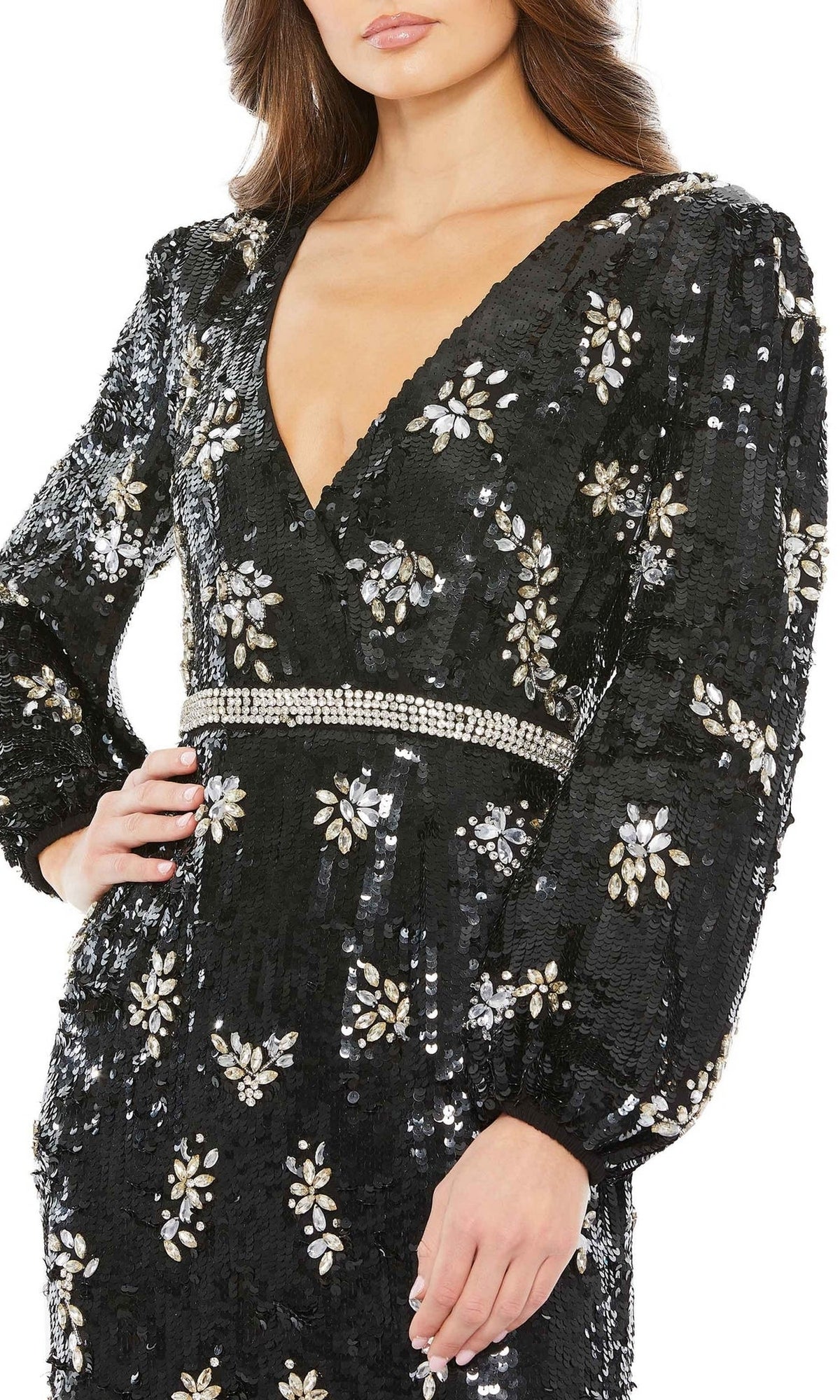 A woman in the Long Formal Dress 93616 by Mac Duggal—an elegant black sequin gown with long sleeves, deep V-neckline, floral embellishments, and a beaded waistband—perfect for special occasions.