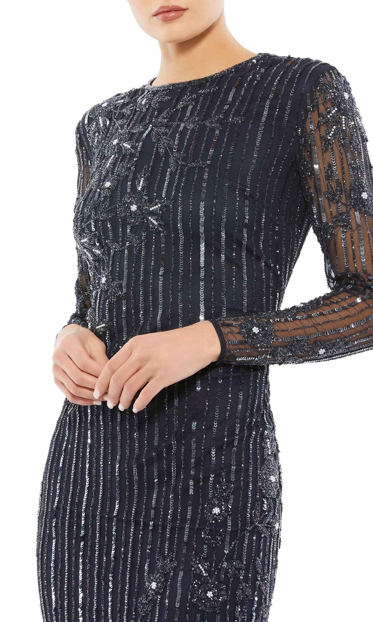 A woman wears the Mac Duggal 93626 Long Sleeve Sequin Formal Gown, featuring vertical metallic stripes and sequin embellishments, shown from shoulders to mid-thigh.