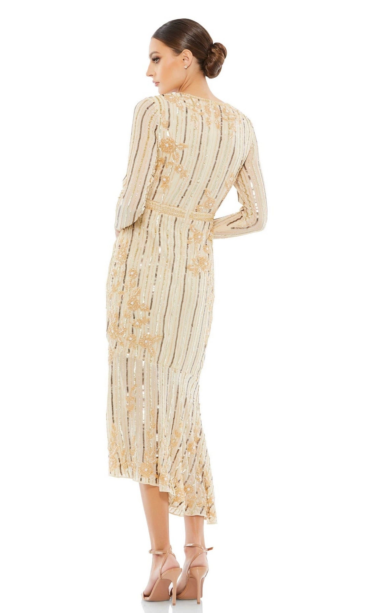 A woman wears the Mac Duggal 93627 Midi Sequin Wedding Guest Dress with long sleeves and gold detailing, paired with heels, as she faces away from the camera.