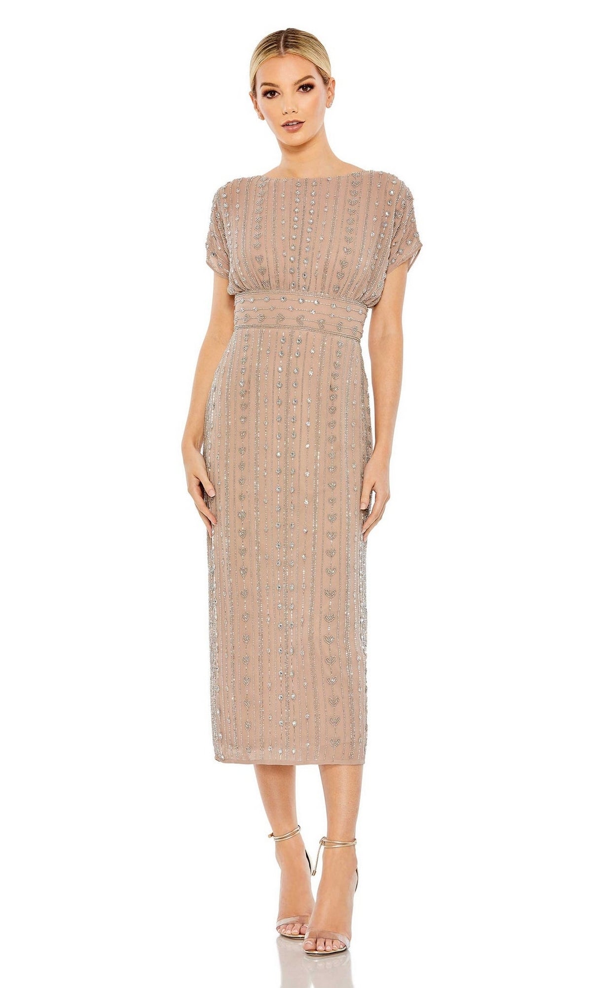 A woman models the Mac Duggal Beaded Short Wedding-Guest Dress 93649, featuring taupe sequined vertical patterns, short sleeves, and knee-length design. She stands with her arms at her sides in strappy heels against a white background.