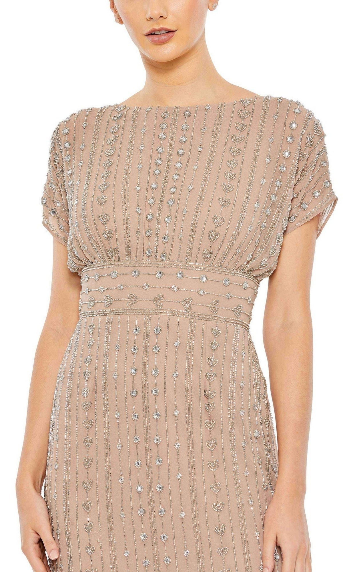 A woman wears the Mac Duggal Beaded Short Wedding-Guest Dress 93649, featuring short sleeves, a blush hue, an empire waist, and vertical silver bead and sequin embellishments.