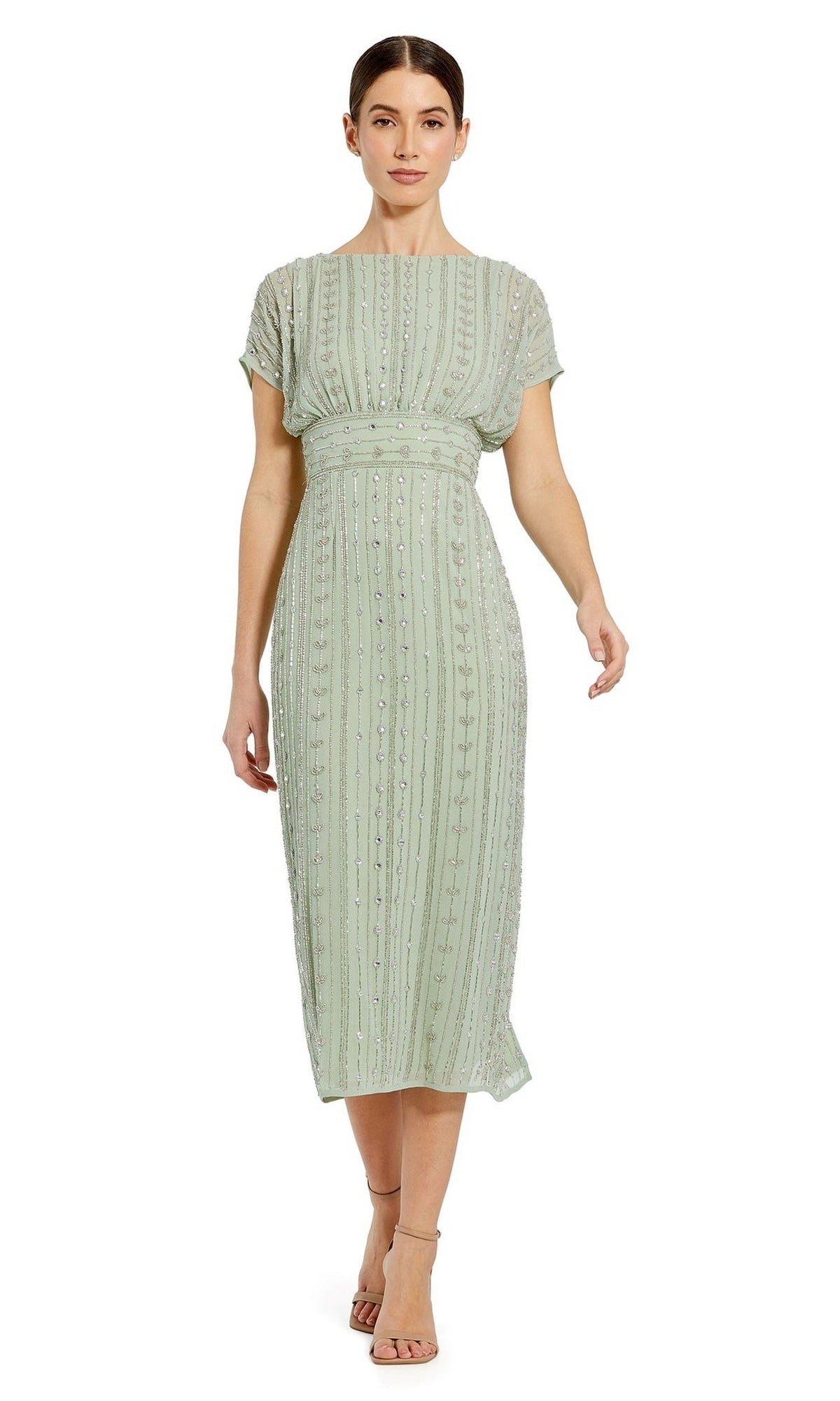 A woman wearing the Mac Duggal Beaded Short Wedding-Guest Dress 93649 in light green with short sleeves, mid-length cut, vertical bead embellishments, and nude strappy heels.