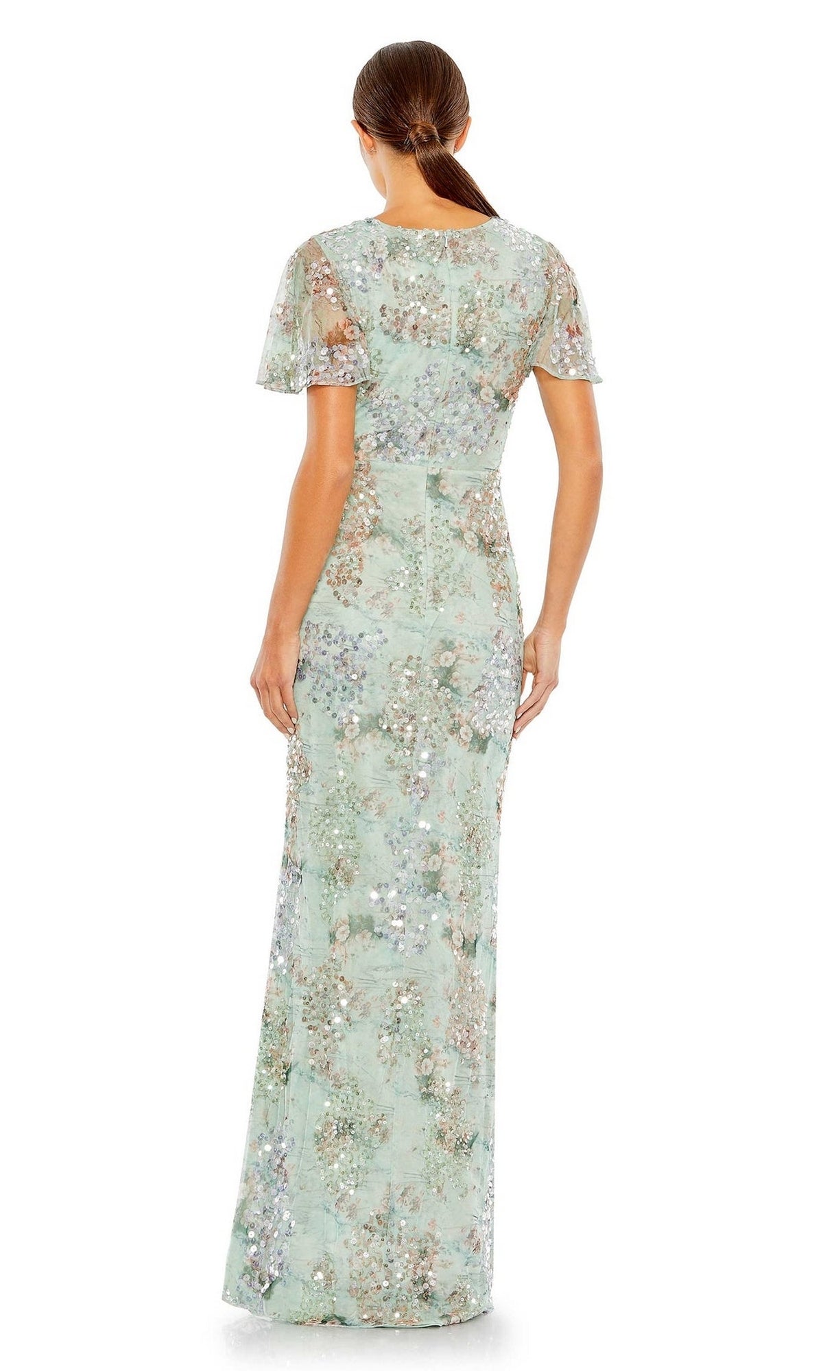 A woman is shown from the back wearing the Mac Duggal 93749 Short Sleeve Beaded Formal Dress, a light blue floor-length gown with sequin embellishments and floral details.