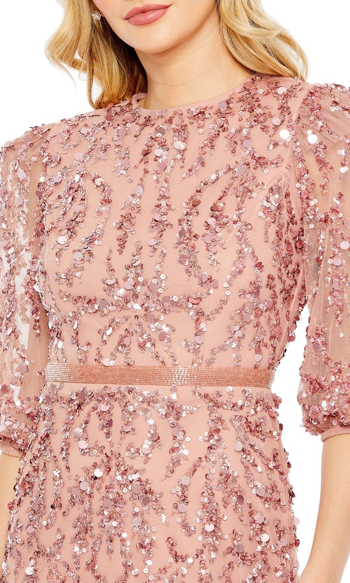 A woman wears the Mac Duggal 93790 Long Sleeve Beaded Formal Dress in pink, adorned with sequins and beads, featuring semi-sheer puff sleeves and a fitted waist.