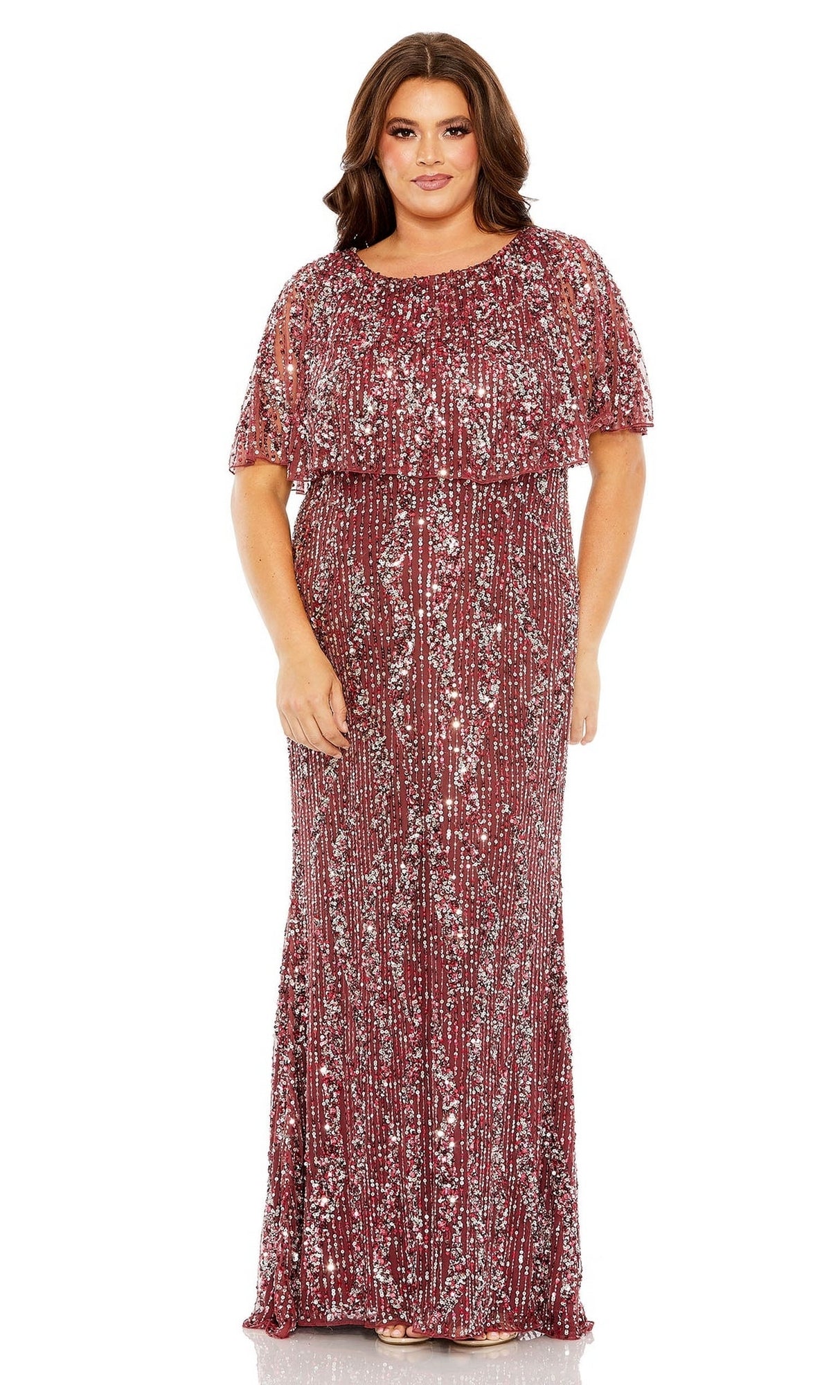 A woman faces forward in the Plus-Size Long Sequin Prom Dress Mac Duggal 93867, a floor-length burgundy gown with short sleeves and silver sequin embellishments.