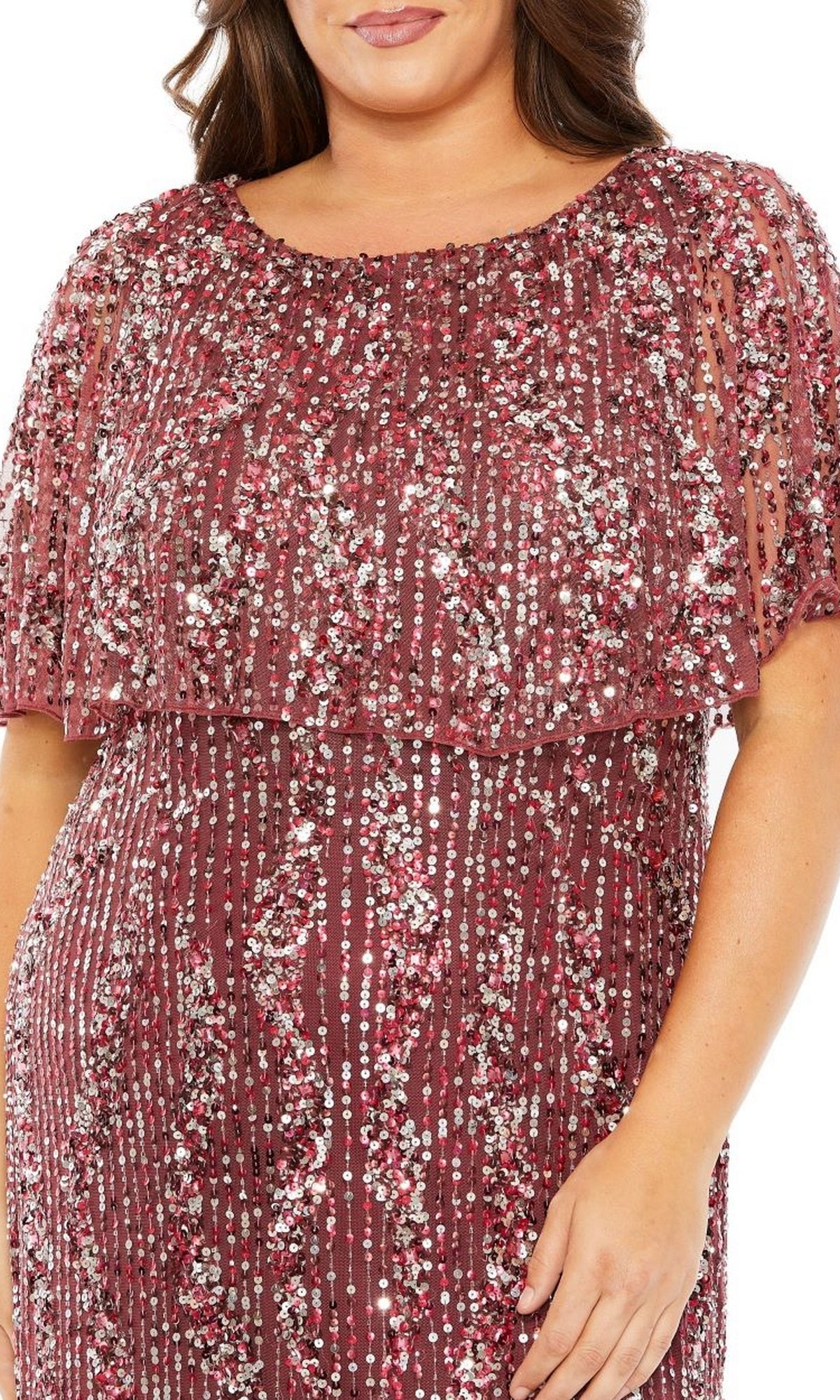 A person wears the Mac Duggal 93867 Plus-Size Long Sequin Prom Dress, featuring rose-colored sequins, short sleeves, and a layered beaded overlay—ideal for formal occasions.