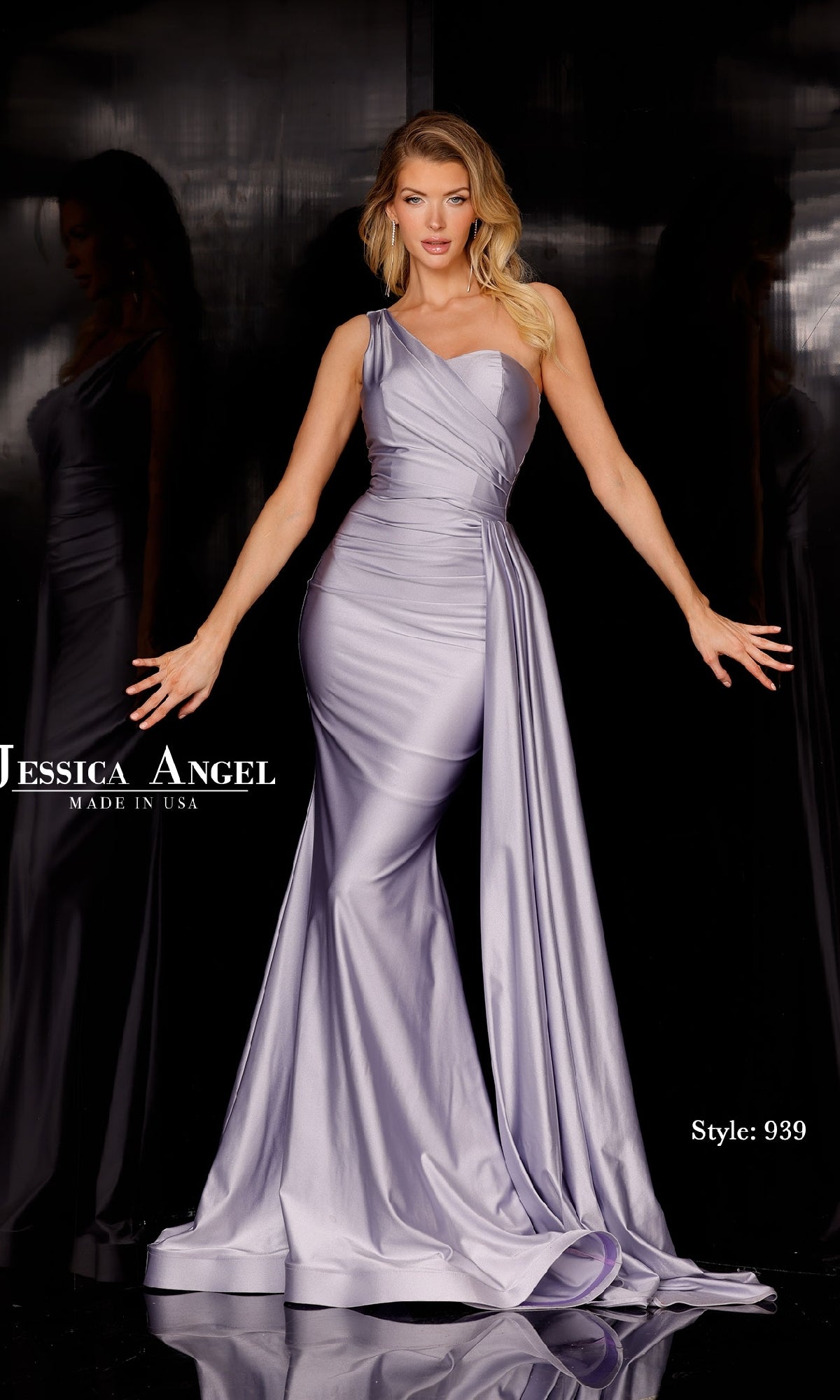 A woman poses against a dark backdrop in the Side-Drape Long Prom Dress: Jessica Angel 939, featuring a fitted one-shoulder design with a mermaid skirt and draped detail.