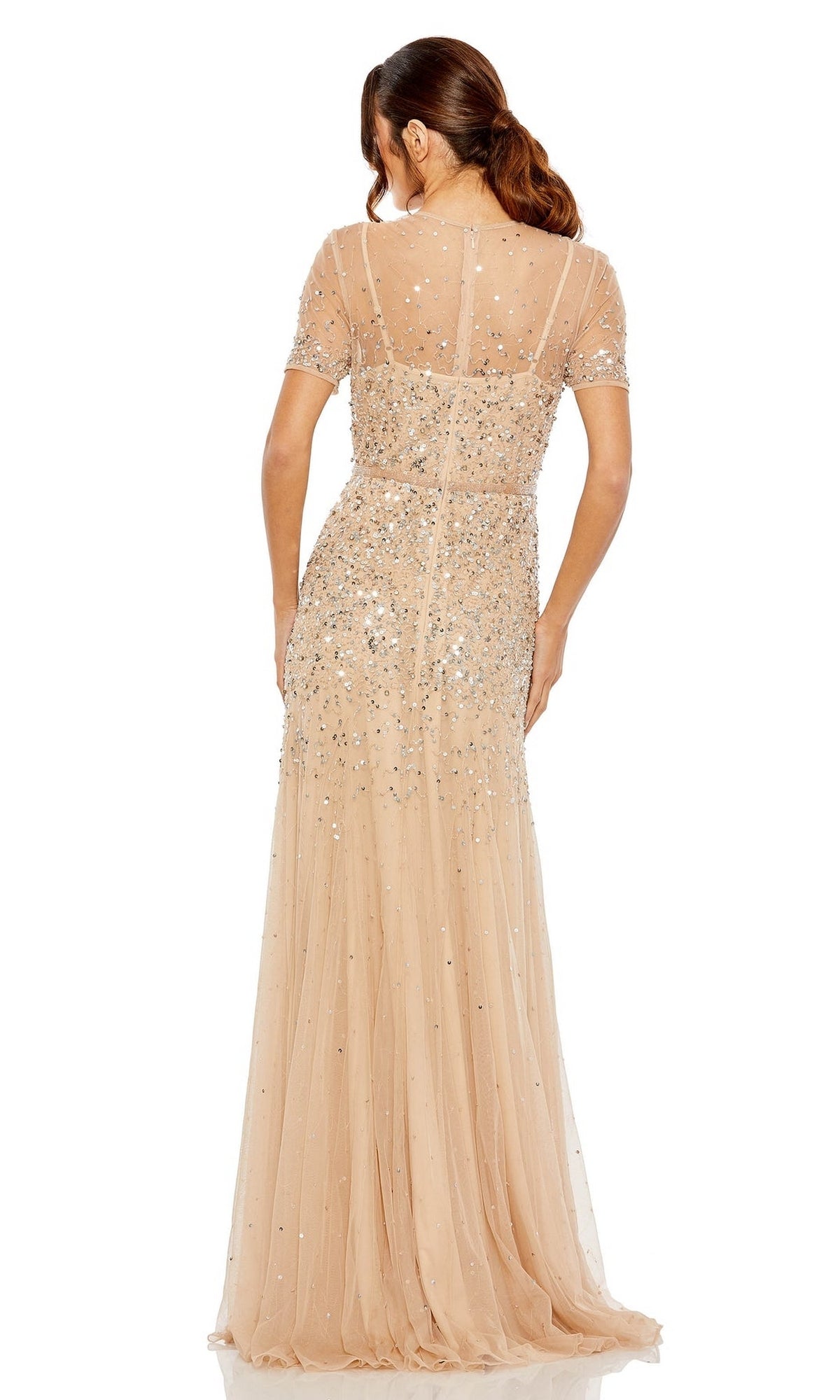 A woman models the Mac Duggal Sheer High-Neck Sequin Formal Dress 93909, a floor-length, nude gown with short sleeves and a beaded waist, shown from the back against a white background.