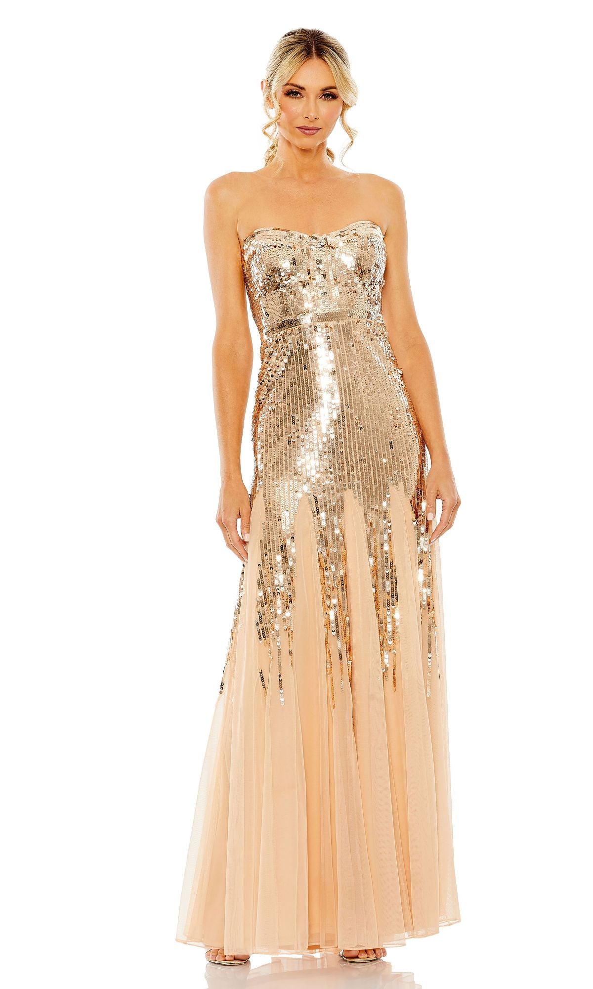 A woman wears the Mac Duggal 93959 Strapless Sequin Formal Dress, featuring a gold sequin bodice and upper skirt with a sheer peach tulle lower skirt—an elegant evening gown for formal occasions.