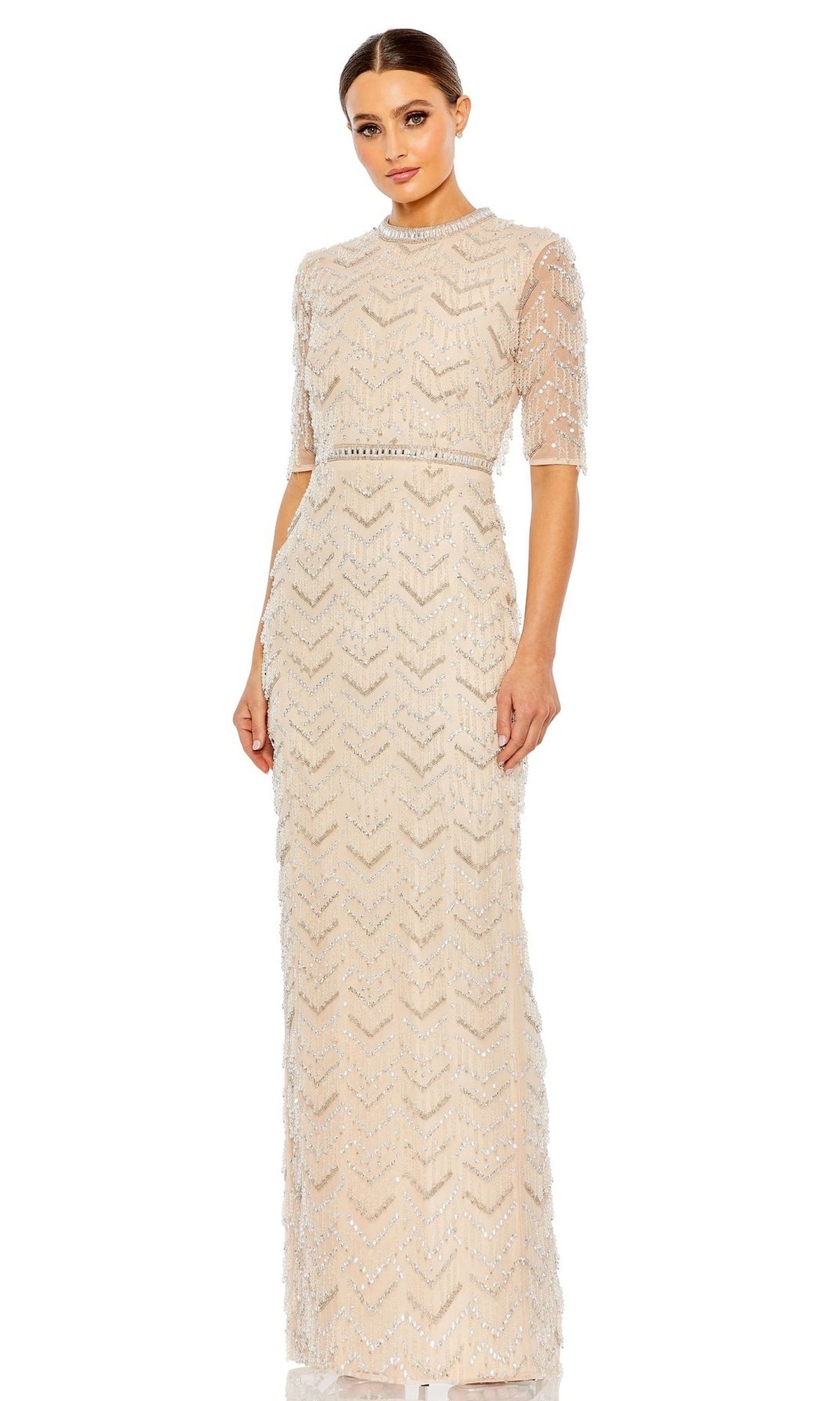 A woman stands facing forward against a white background, wearing the Mac Duggal Beaded Fringe Long Formal Dress 94071 in nude with sheer sleeves and intricate beaded details.