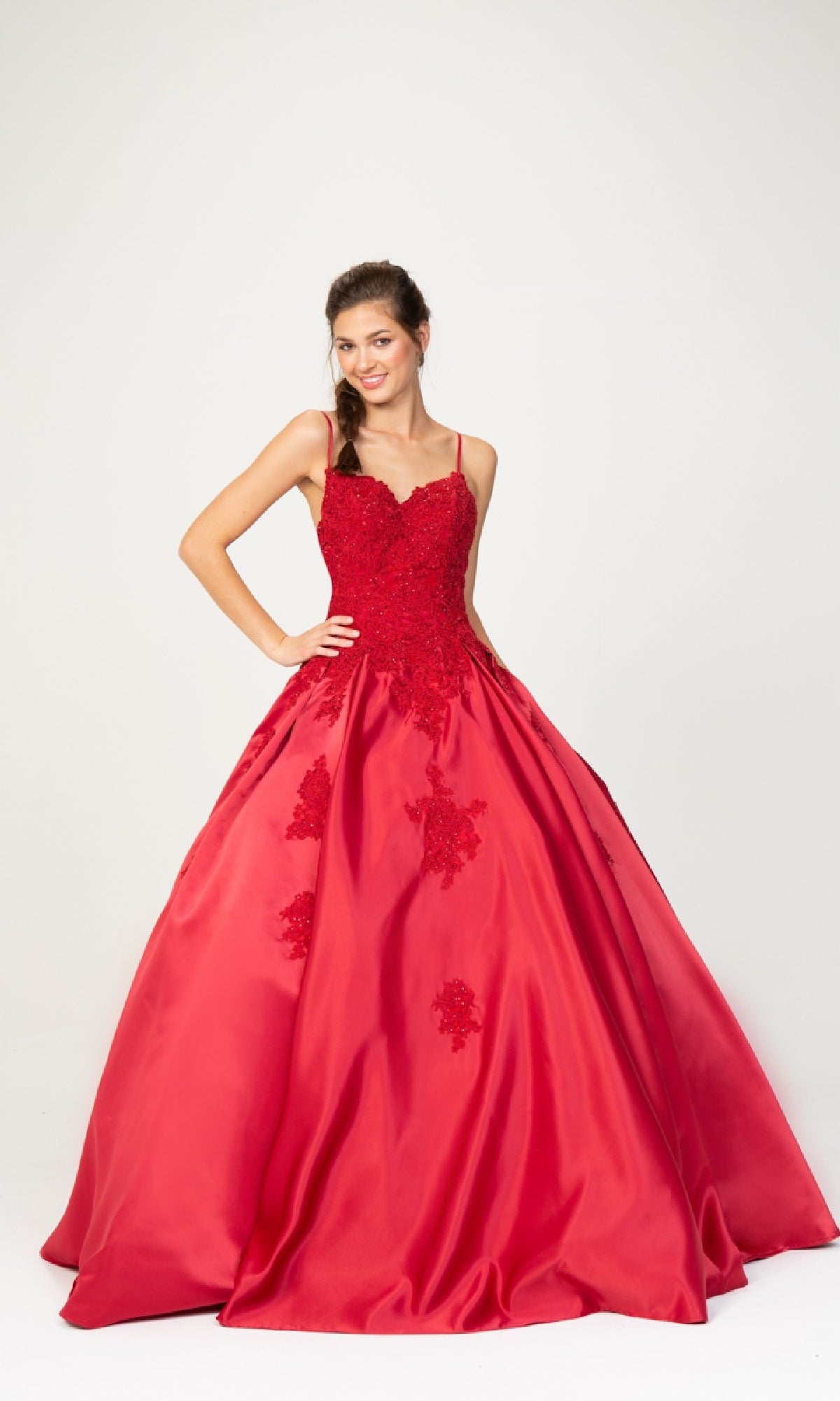 A woman models the Classic Long Prom Ball Gown: Eureka 9500, featuring a red fitted bodice, floral lace details, and an elegant lace-up back, against a plain white background.
