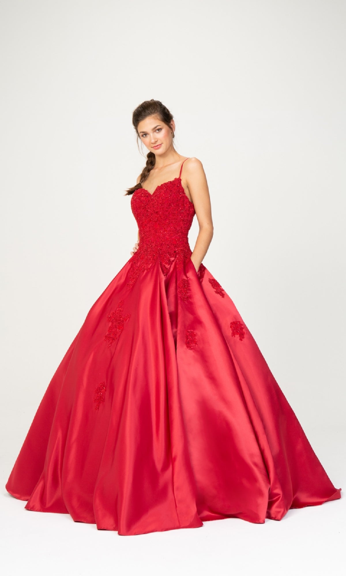 A woman models the Classic Long Prom Ball Gown: Eureka 9500, featuring a fitted bodice, full skirt, and lace-up back, against a plain white background.
