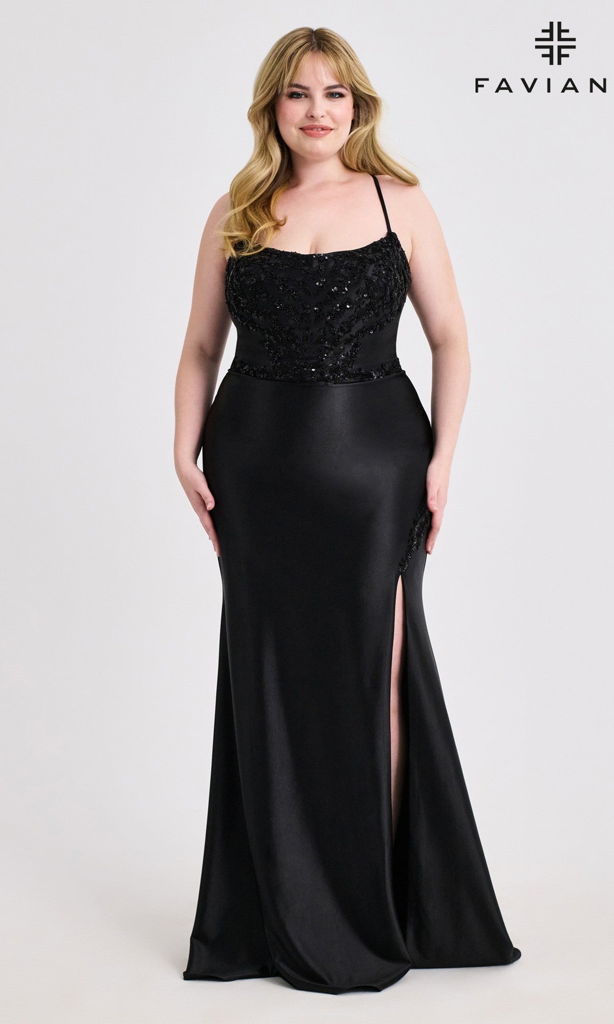 A woman models the Lace-Up Plus-Size Long Prom Dress: Faviana 9606—a floor-length black gown with sequin details, a beaded corset, and a thigh-high slit—against a plain background, with