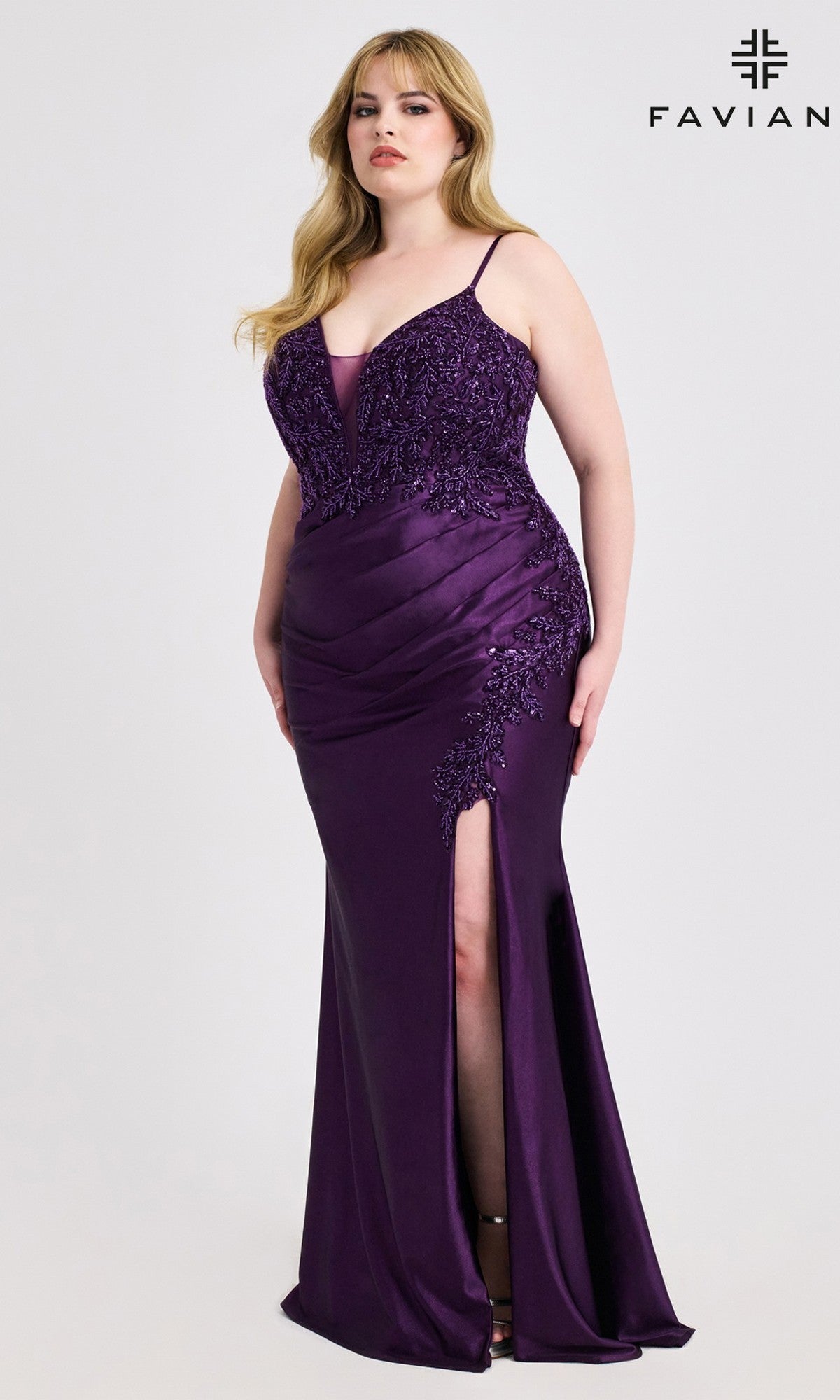 A woman models the Plus-Size Beaded-Bodice Prom Gown, Faviana 9608, in deep purple with a satin finish, beaded bodice, thigh-high slit, lace details, and thin straps against a white background.