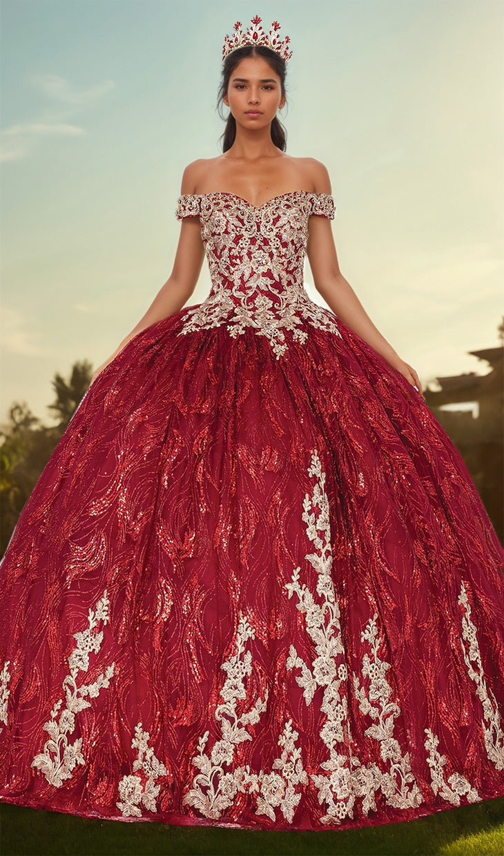 A young woman stands outdoors wearing the Burgundy Quinceanera Dress 1579—an ornate red and white ball gown with gold embroidery, floral patterns, a sweetheart neckline, and a matching crown.
