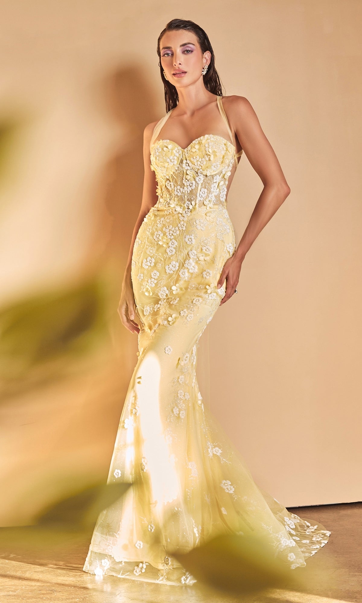 A woman poses in the Long Formal Mermaid Prom Dress with Daisies A1115, a fitted, strapless yellow gown featuring floral embroidery and a sheer skirt, set against a neutral background.