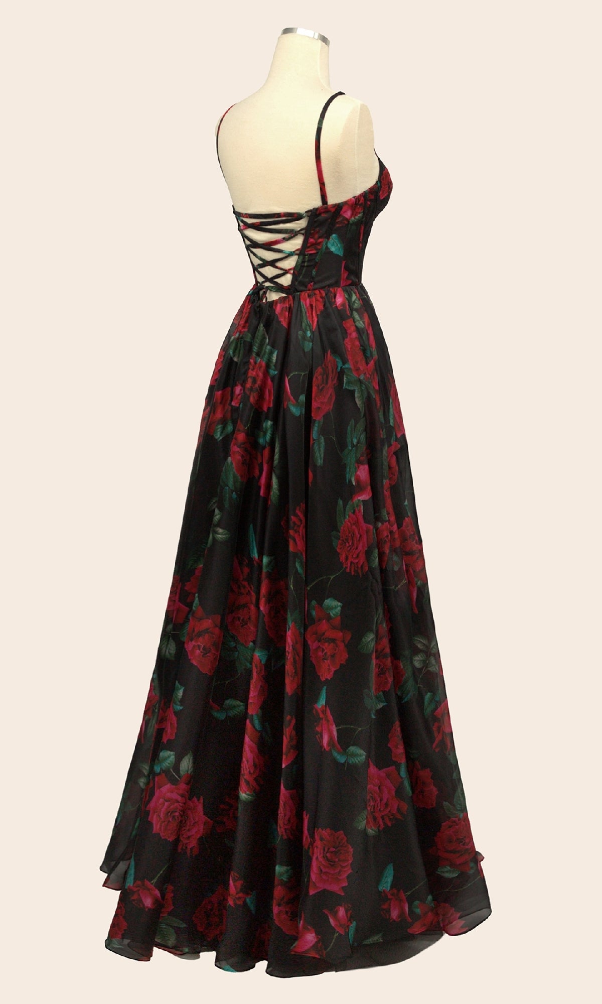 The Andrea & Leo A1465 is a long floral-print prom dress with red rose patterns, thin straps, a fitted bodice, and a lace-up back, displayed on a dress form.