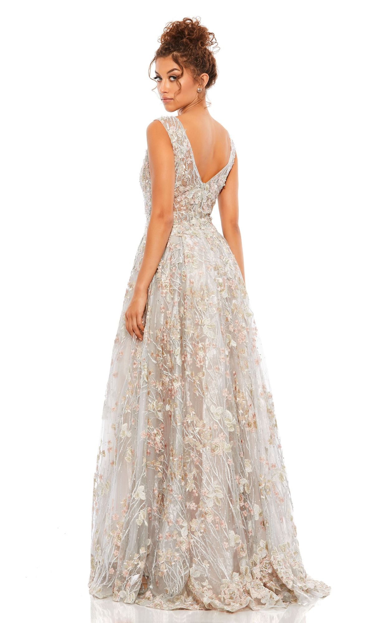 Woman in the Mac Duggal A20131 Embroidered Long Formal Dress, sleeveless and floor-length with floral embroidery, stands with her back to the camera against a white background.