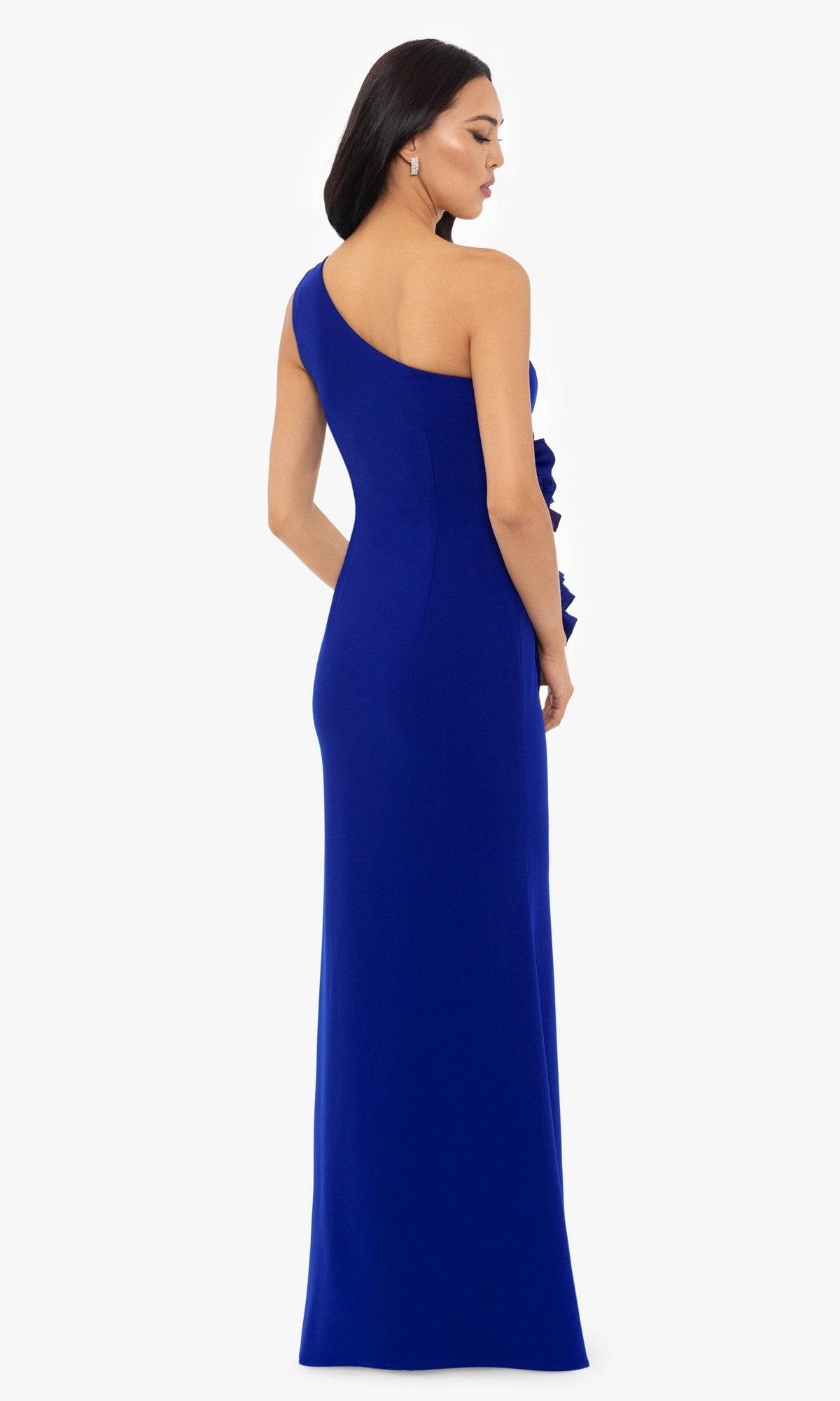 A woman in the Betsy and Adam One-Shoulder Long Prom Dress A26071, a sleeveless floor-length royal blue gown, stands facing away against a white background.