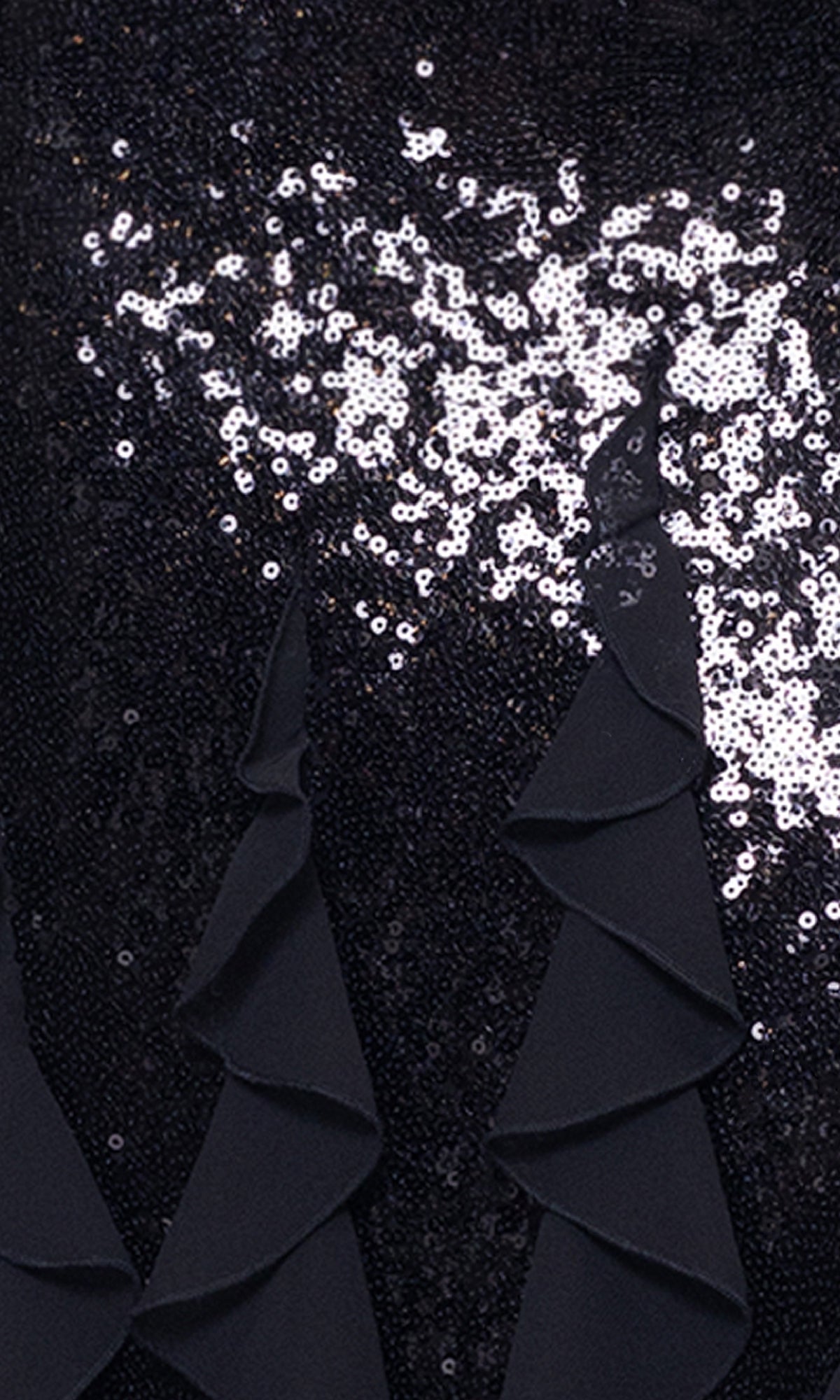 Close-up of the Betsy & Adam A26805 long black sequin formal gown, featuring shiny silver sequins and three triangular, ruffled black fabric accents at the hem.