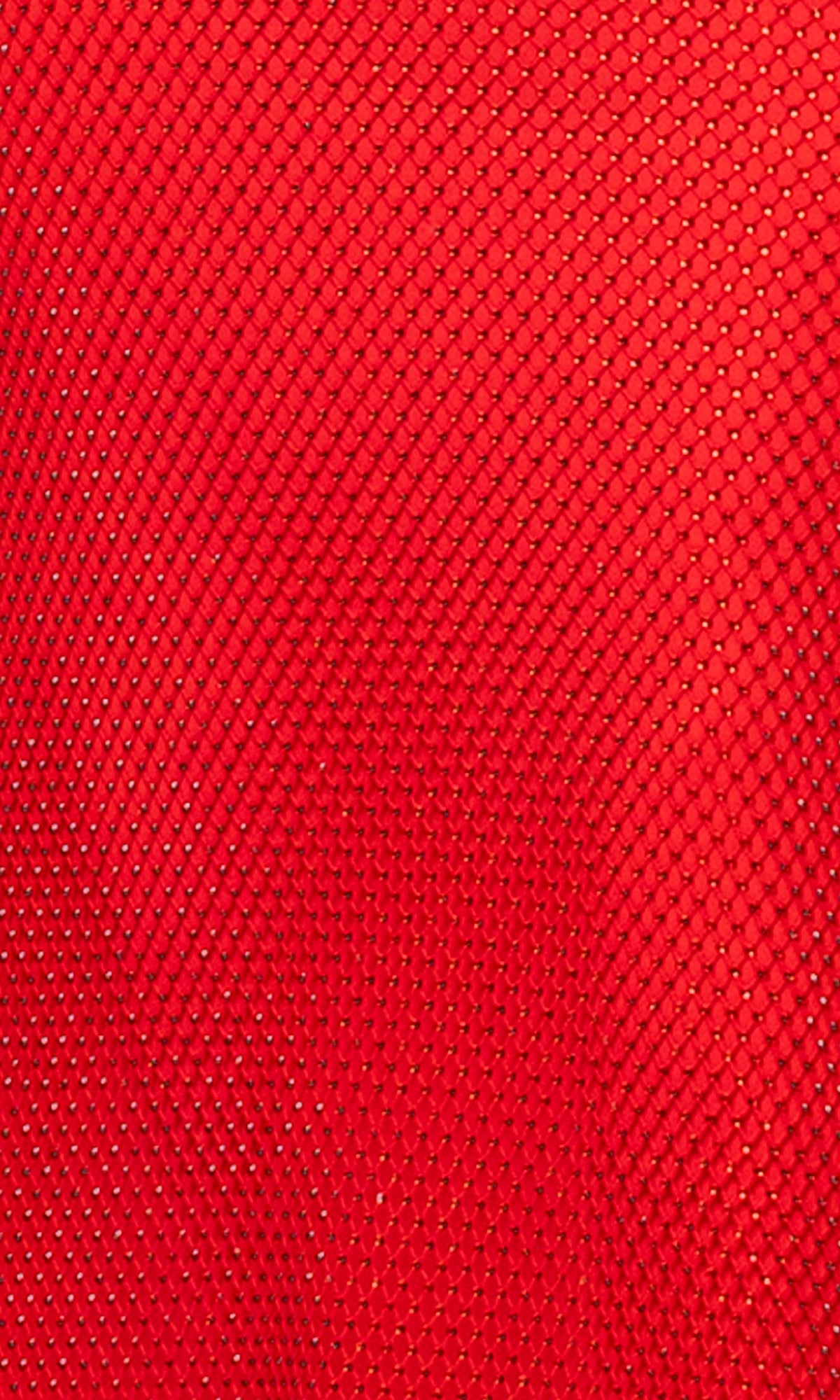 Close-up of the Long Formal Dress: Betsy and Adam A27001, showing its red stone mesh fabric with a diamond pattern, emphasizing the texture and small holes in the material.