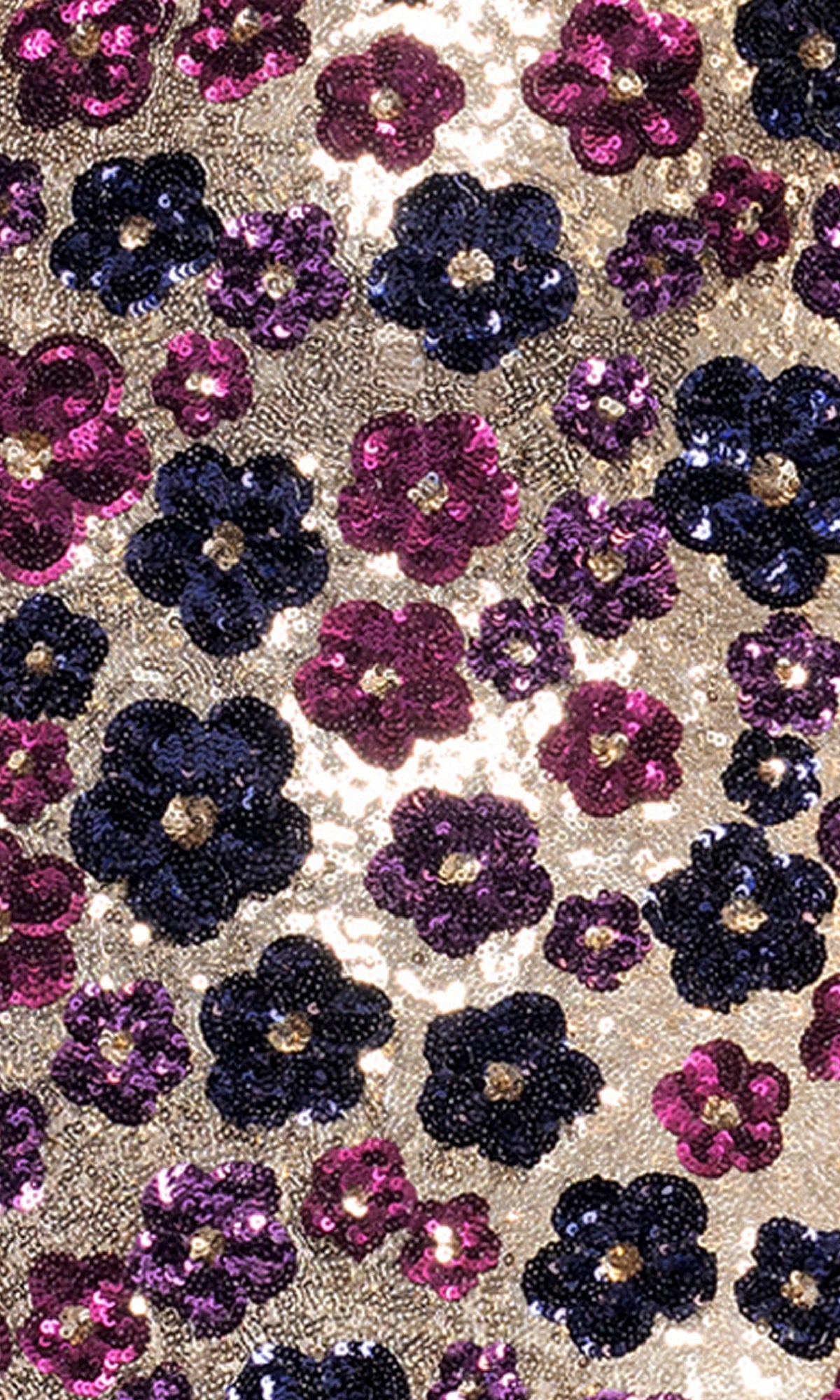 Close-up of gold fabric with shiny blue and purple sequin floral patterns, similar to the stunning Floral-Sequin Long Prom Dress: Betsy & Adam A27017.