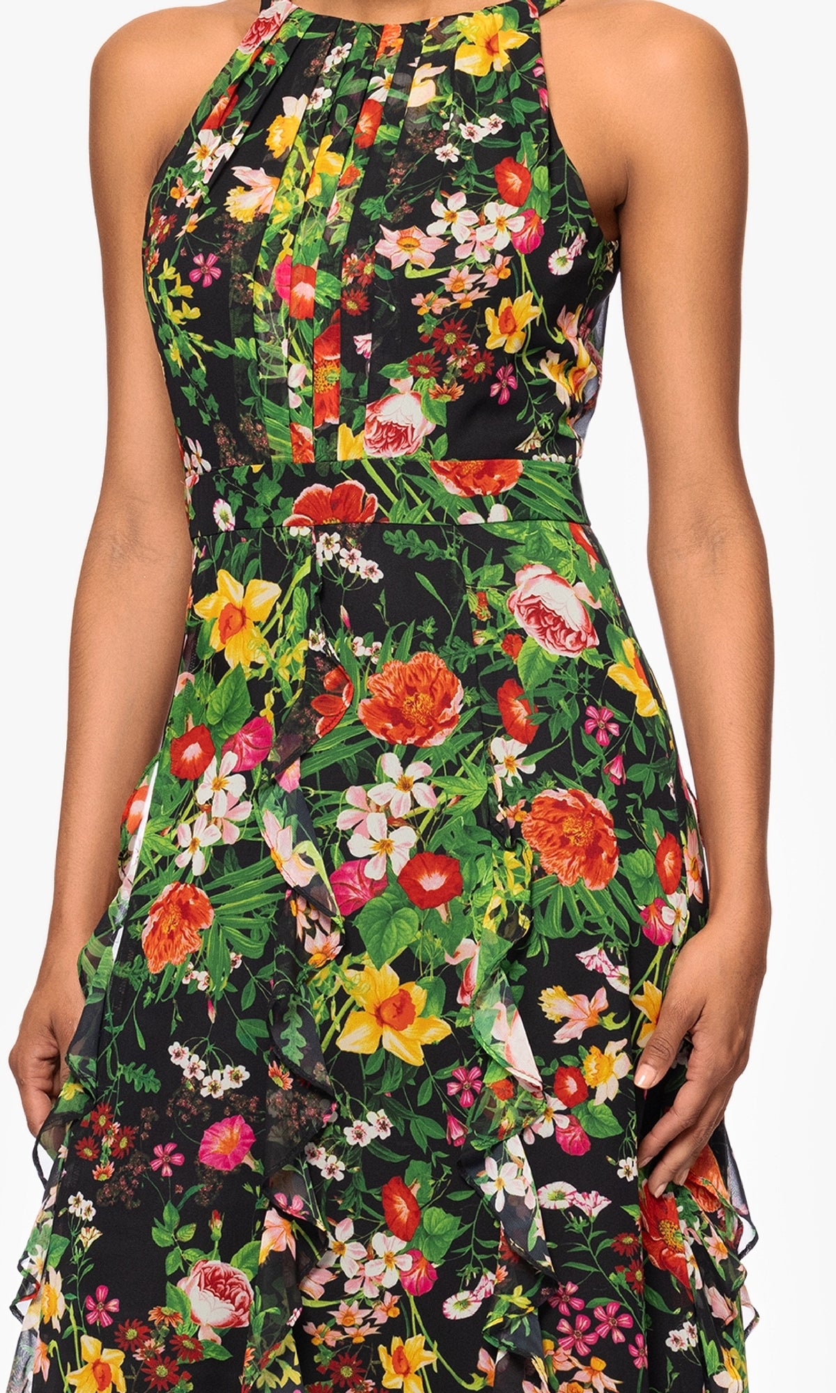 The Betsy & Adam A27102 is a sleeveless, high-neck dress with a pleated bodice and vibrant multicolor floral print on black—perfect as a floral wedding guest dress.