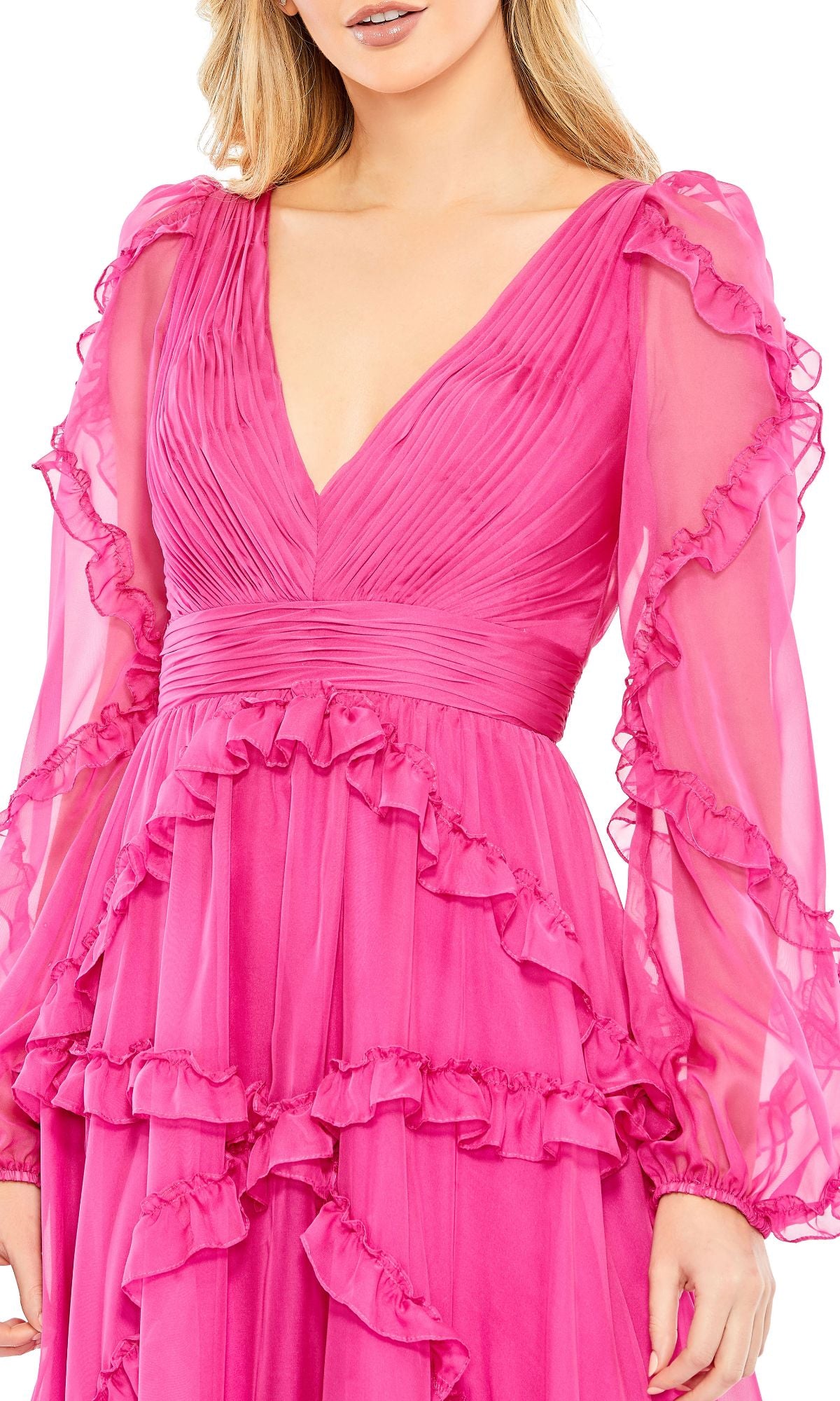 A woman wearing the Mac Duggal A68223 long sleeve formal dress in bright pink, featuring pleated details and ruffled layers.