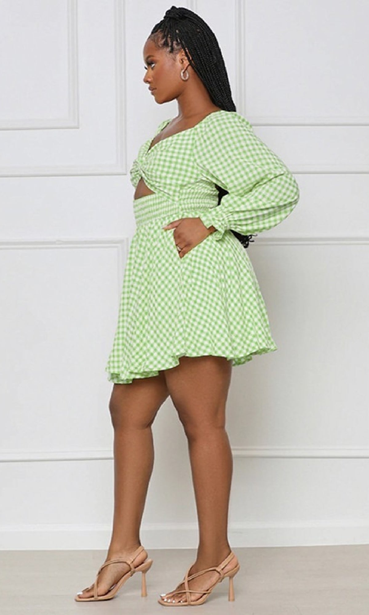 Woman in profile wearing the Long-Sleeve Short Casual Gingham Print Dress, featuring a green and white gingham pattern and flared skirt, styled with nude heeled sandals.