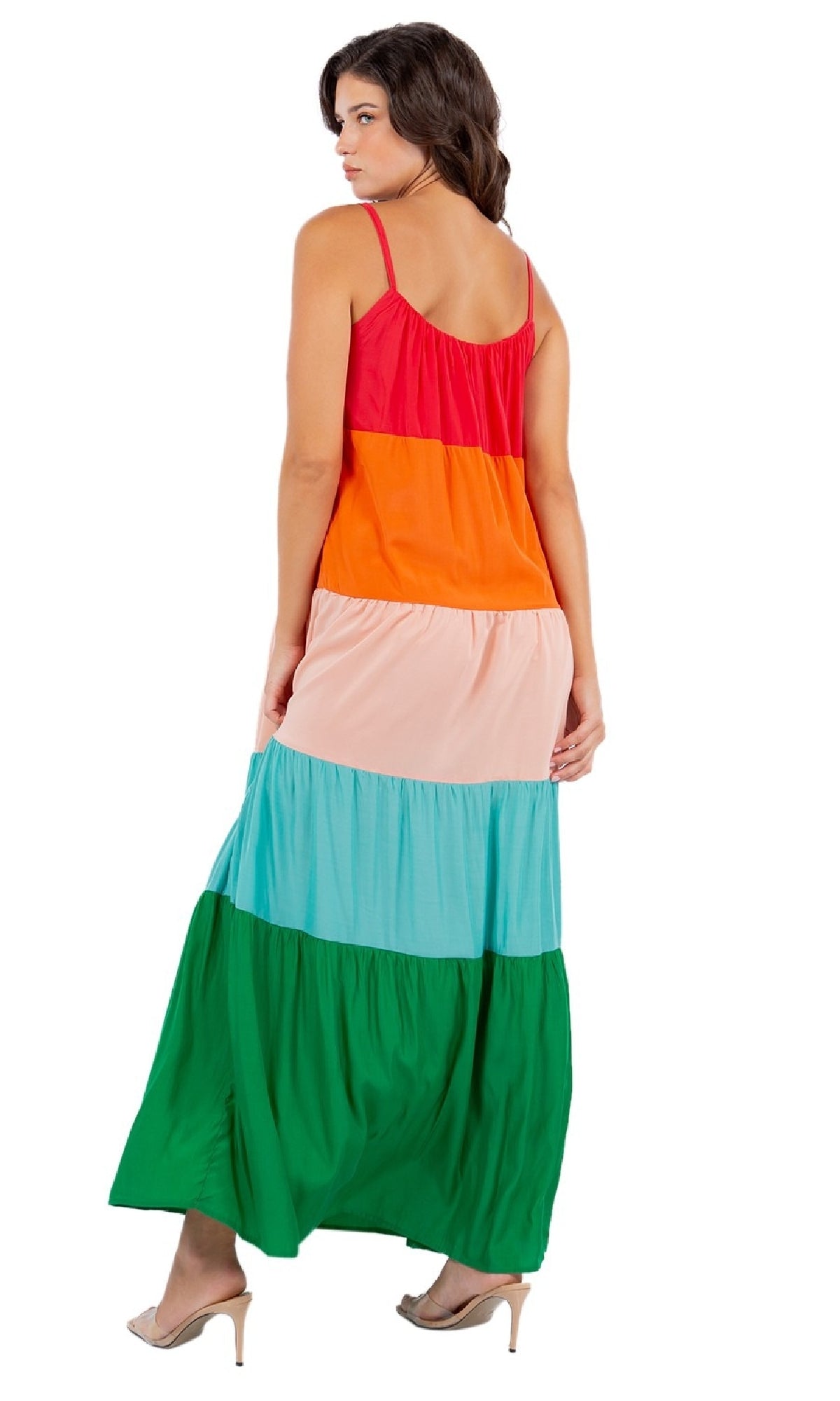 Woman in a Casual Color-Block Maxi Shift Dress featuring sleeveless design and vibrant red, orange, pink, blue, and green tiers, styled with beige high heels and facing away.
