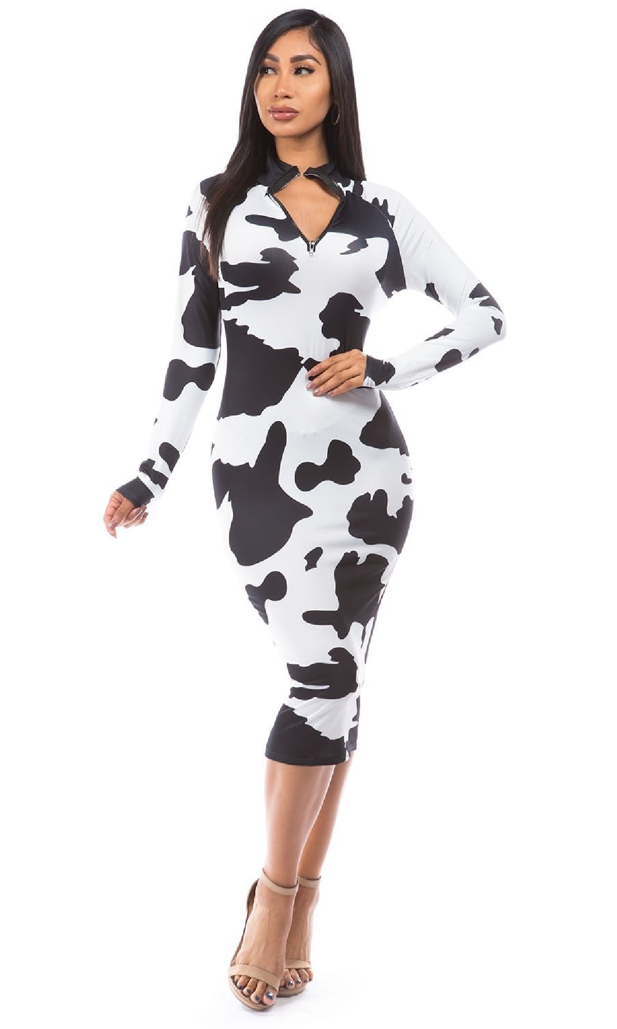 Model wears the Long Sleeve Cow Print Bodycon Midi Dress with a front zipper neckline, paired with heels against a white background.