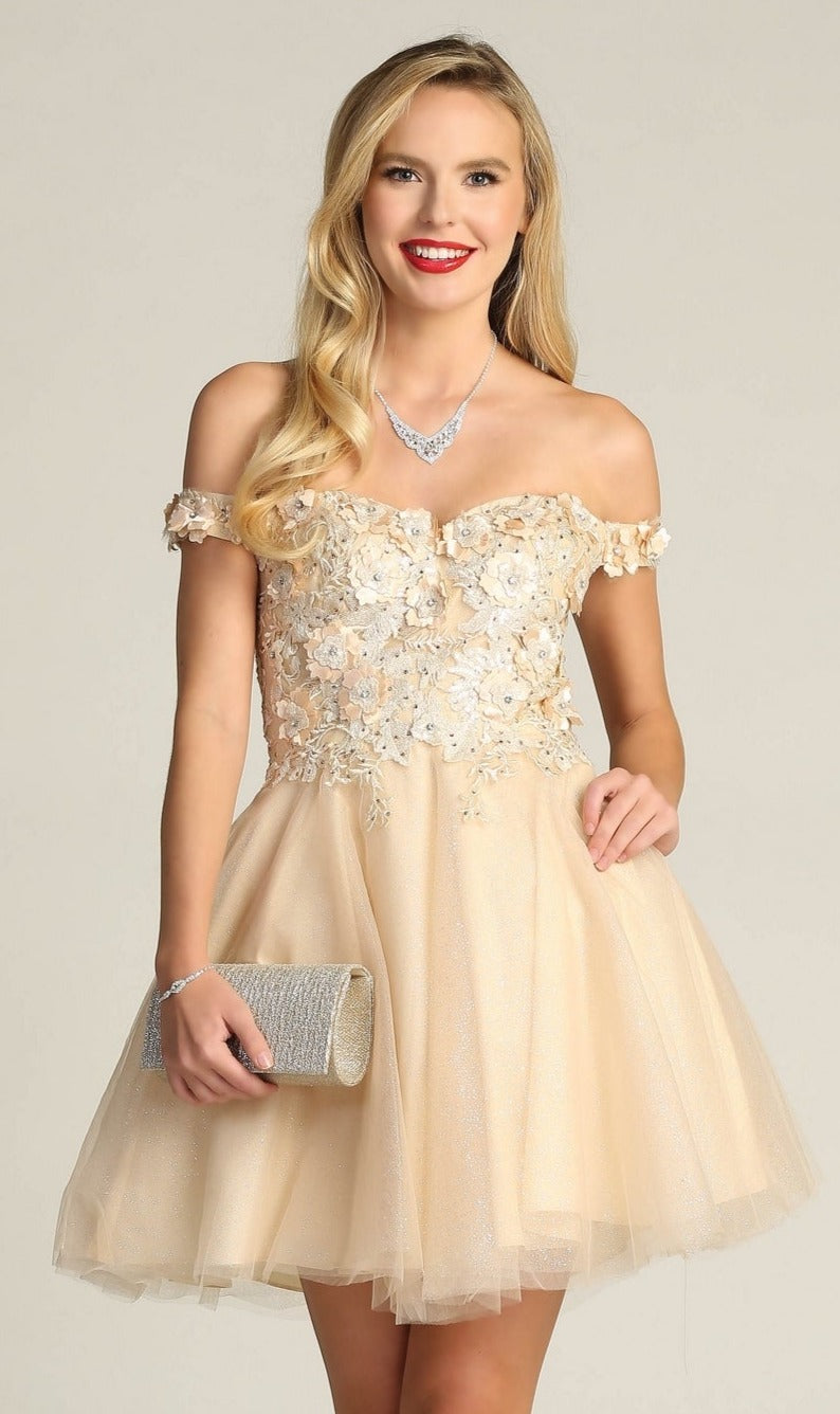 A woman smiles at the camera, holding a silver clutch and wearing the Beaded-Bodice Short A-Line Homecoming Dress C315 in light beige, featuring an off-the-shoulder design with floral embellishments.