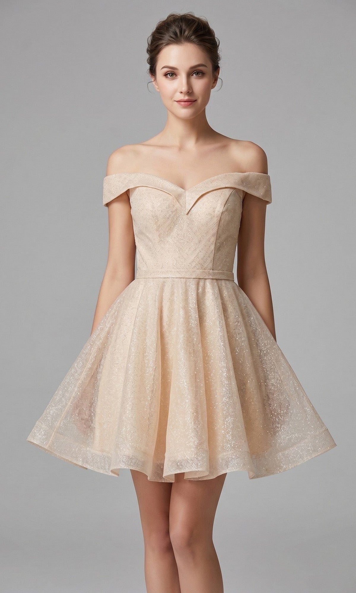 A woman stands against a plain gray background wearing the Chicas C323 short homecoming dress in champagne. The light, off-the-shoulder design features a fitted bodice and flared skirt in an A-line silhouette, accentuating her figure with effortless elegance.
