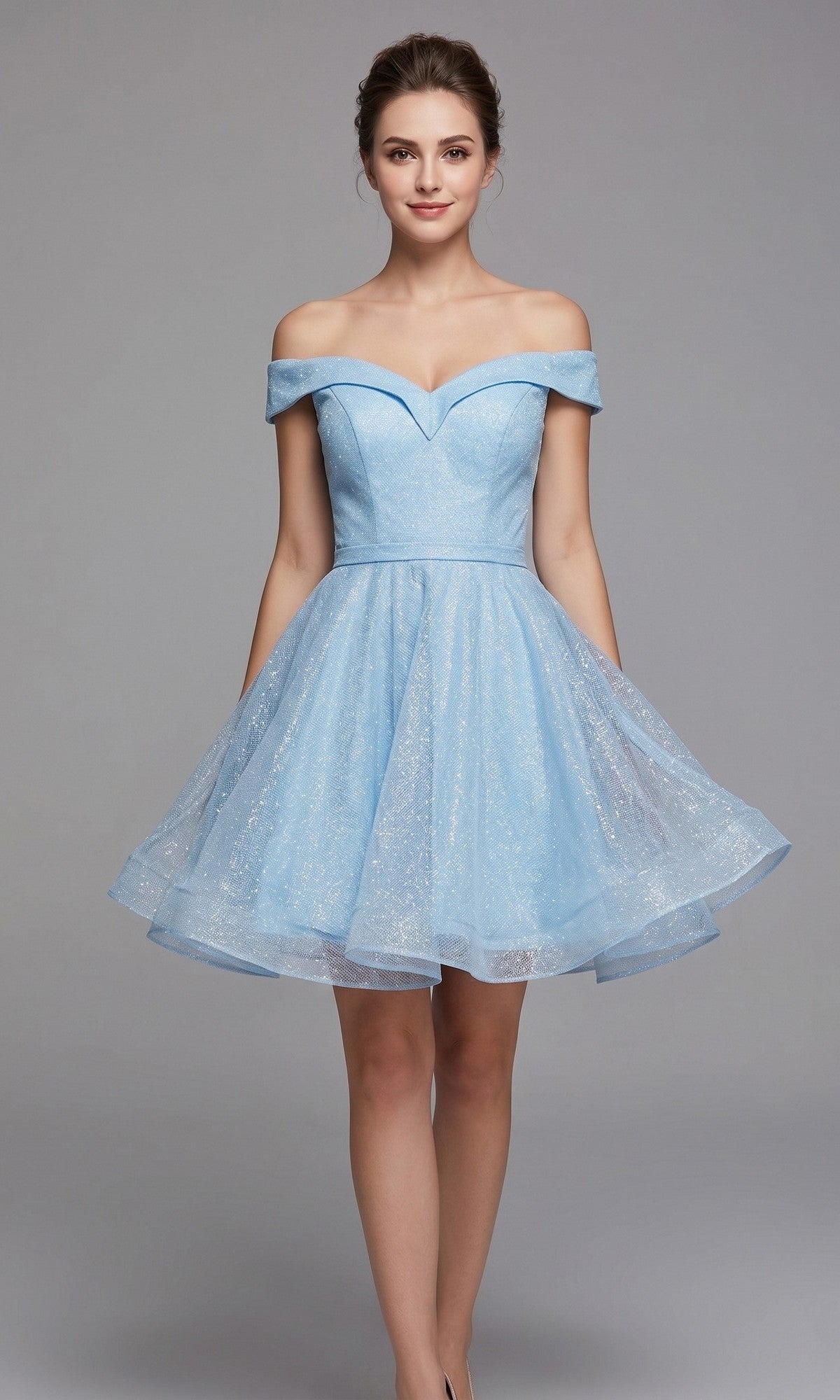 A woman is standing against a plain gray background wearing the Chicas C323 short homecoming dress, an off-the-shoulder fit-and-flare design in light blue glitter fabric, featuring a fitted bodice and flared skirt.