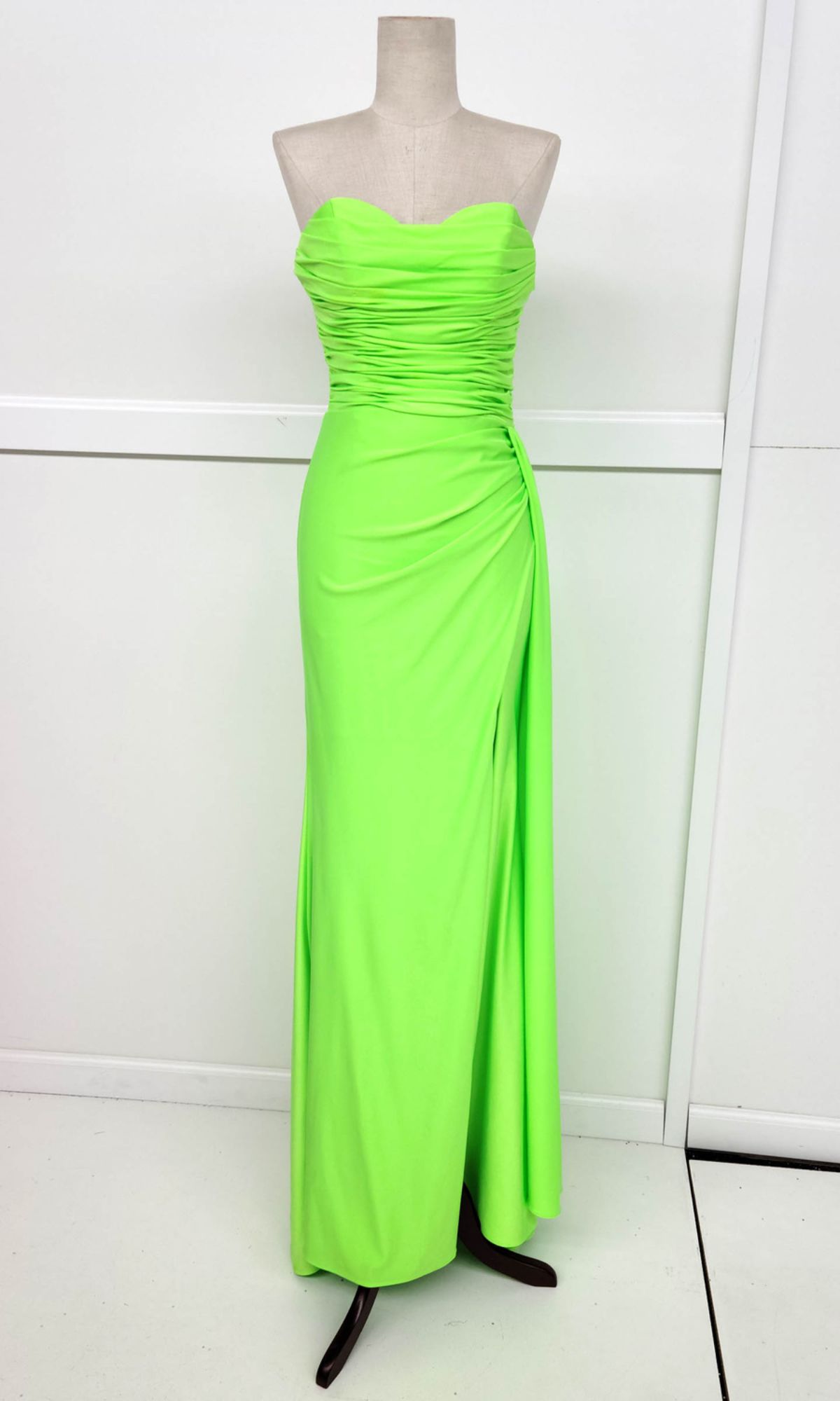 Mannequin showcasing the Chicas C327 Side-Sash Strapless Long Prom Dress in neon green, with a ruched sweetheart bodice and draped side-gathered detail—an eye-catching gown ideal for special occasions.