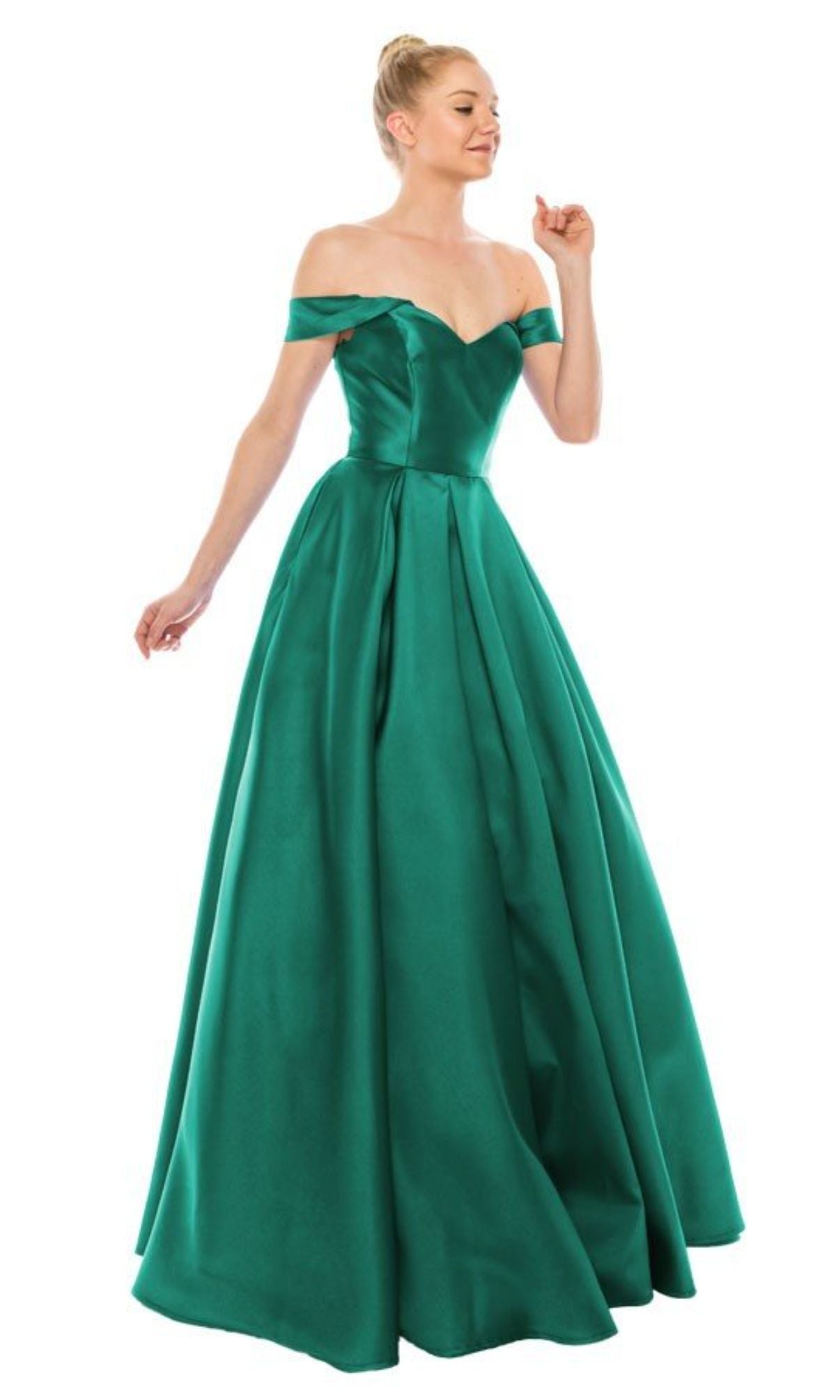 A woman wears the Chicas C9197, an off-the-shoulder, floor-length emerald green prom ball gown featuring a lace-up back, fitted bodice, and full skirt.