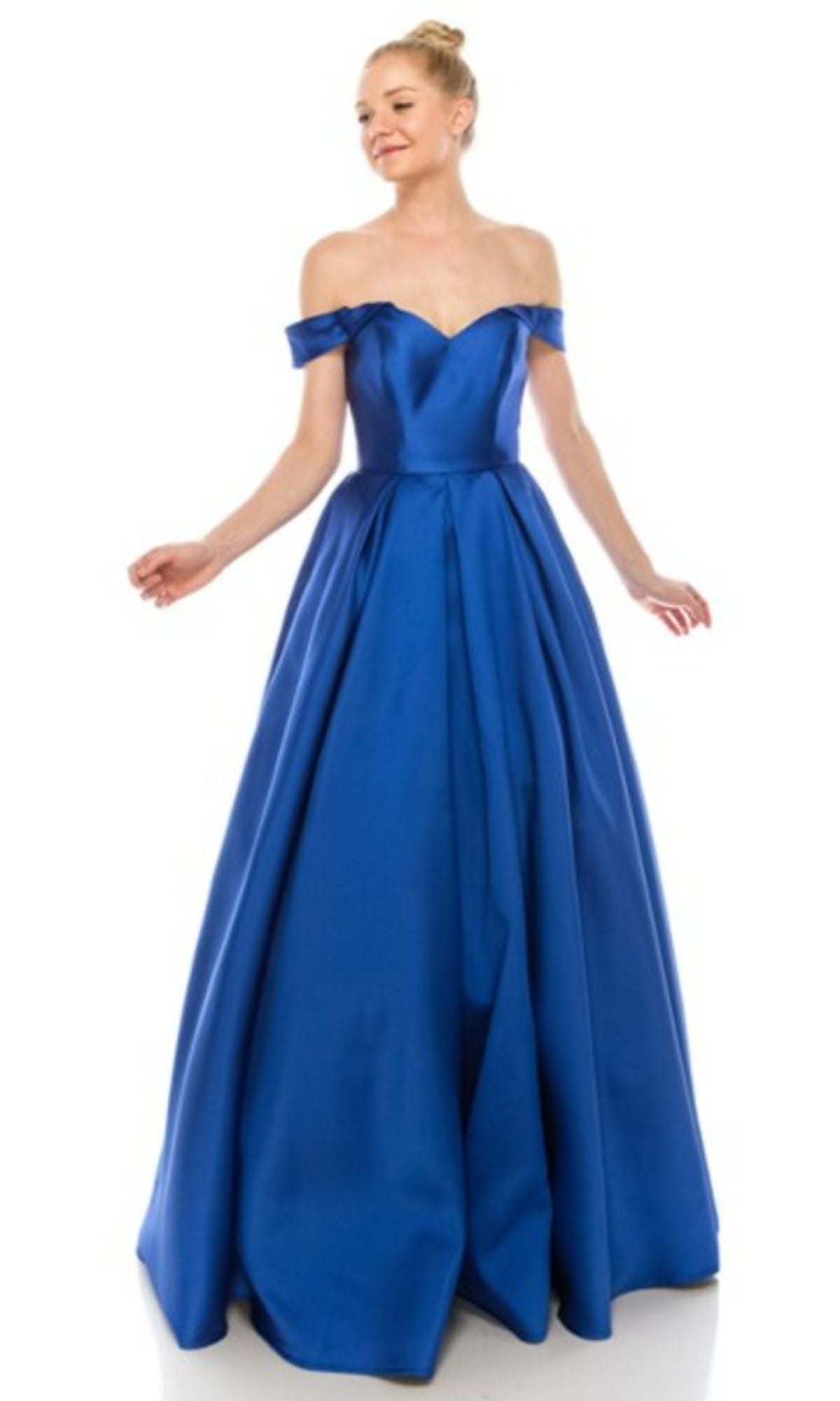 A woman smiles against a plain white background, wearing the Off-the-Shoulder Long Prom Ball Gown: Chicas C9197 in elegant royal blue, floor-length style.