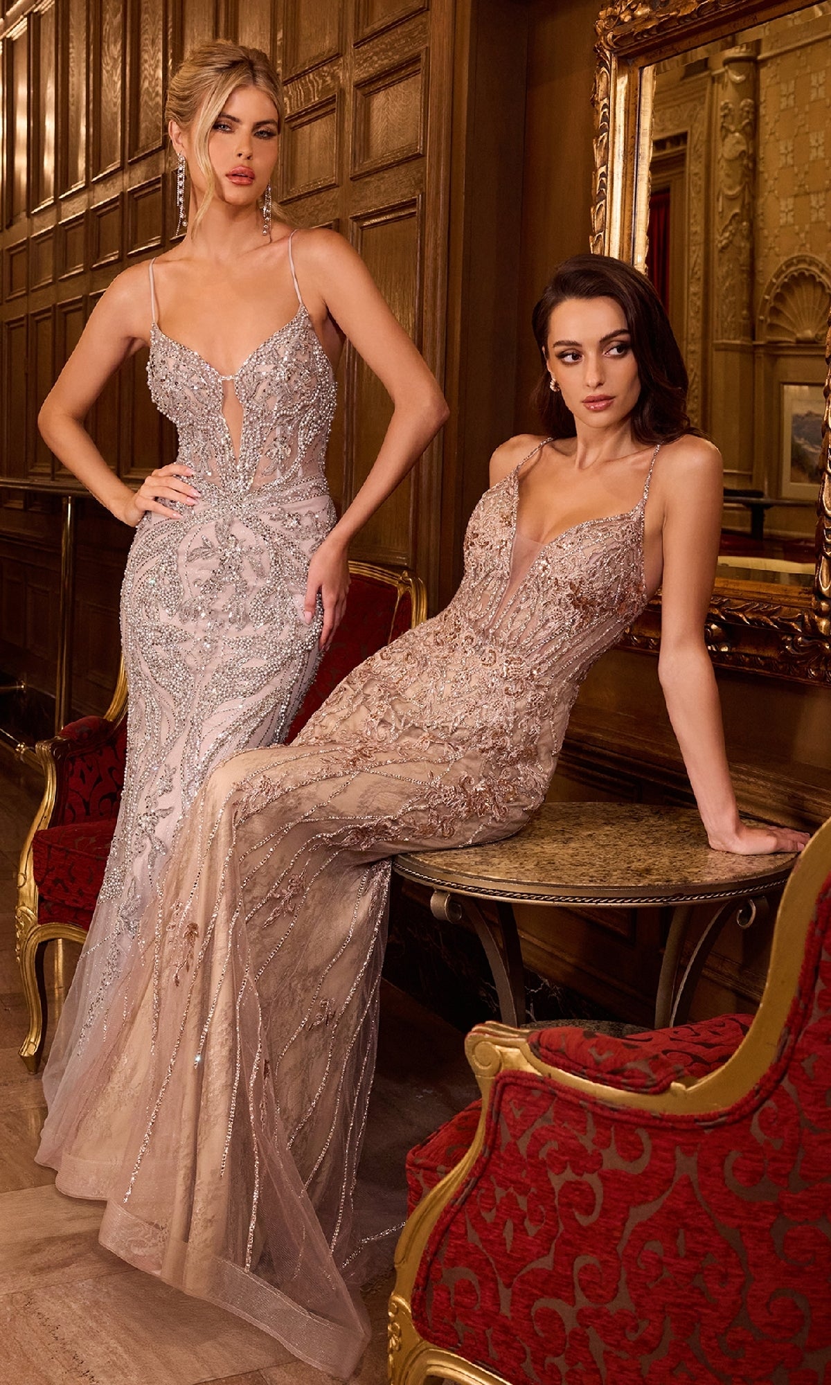 Two women in long evening gowns pose in an ornate room. One wears the tight, long beaded prom dress Ladivine CD795, while the other stuns in an elegant mermaid skirt silhouette.