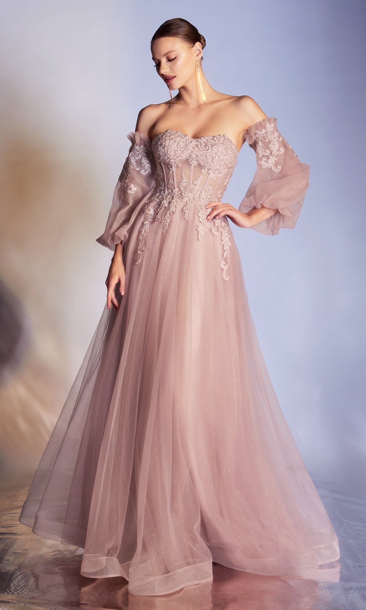 A woman models the Strapless Puff-Sleeve Long Prom Dress CD948 in blush pink, featuring an embroidered bodice and removable puff sleeves, set against a soft gradient background.