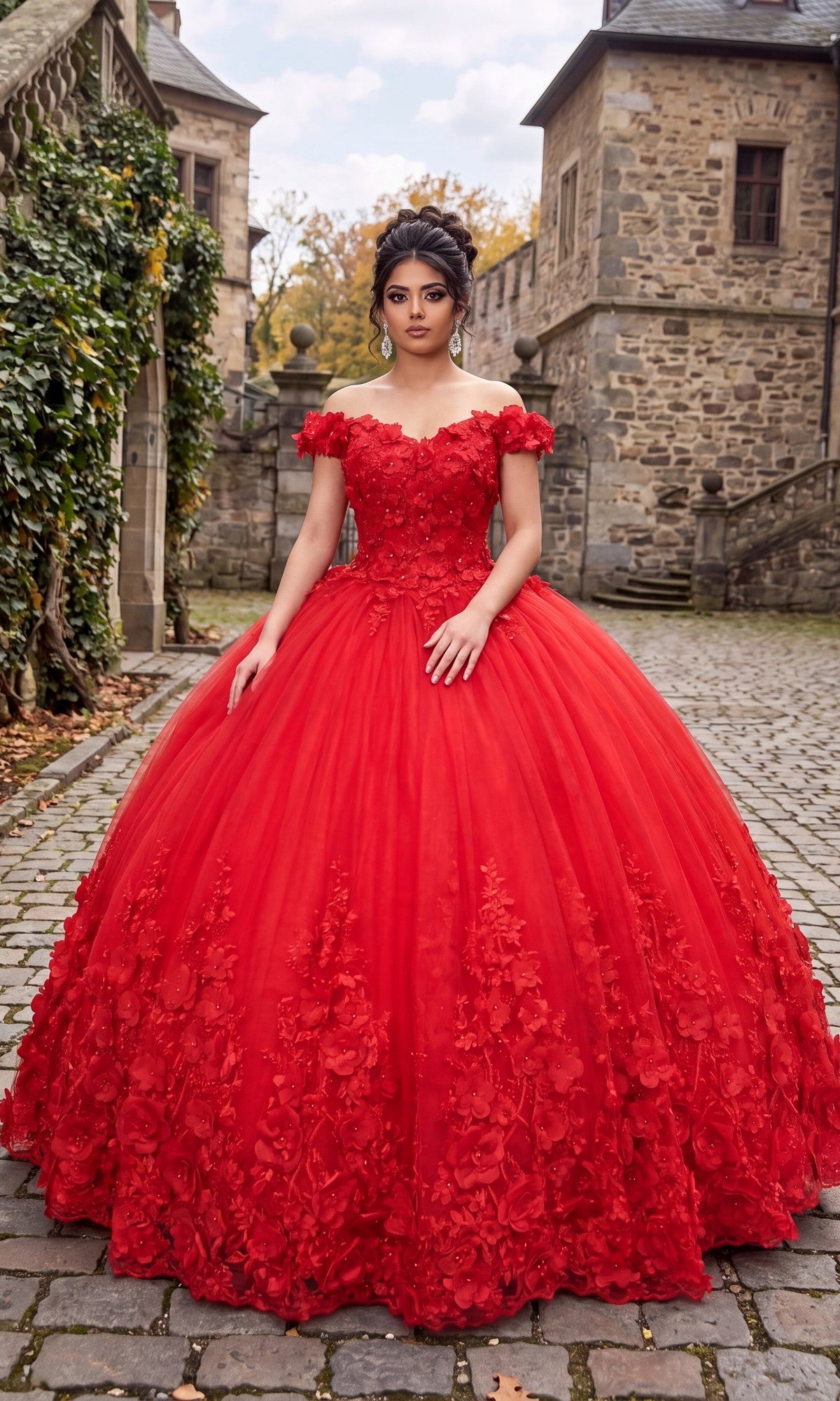 A woman in a striking red Quinceanera Dress CHF3030 By Chicas, featuring ornate off-the-shoulder design and delicate 3D floral accents, stands on a cobblestone path nestled between historic stone buildings, surrounded by lush greenery and trees.