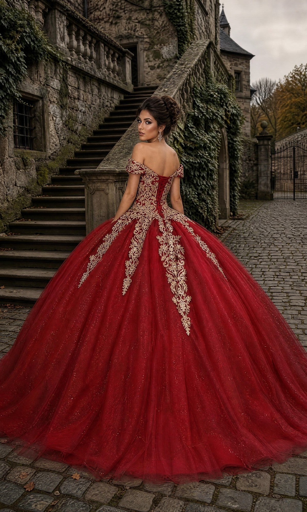 A woman in the Quinceanera Dress CHF3040 By Chicas—a striking, ornate red glitter tulle ballgown with a corset bodice—stands on a cobblestone path near a stone staircase and an ivy-covered building, looking over her shoulder.